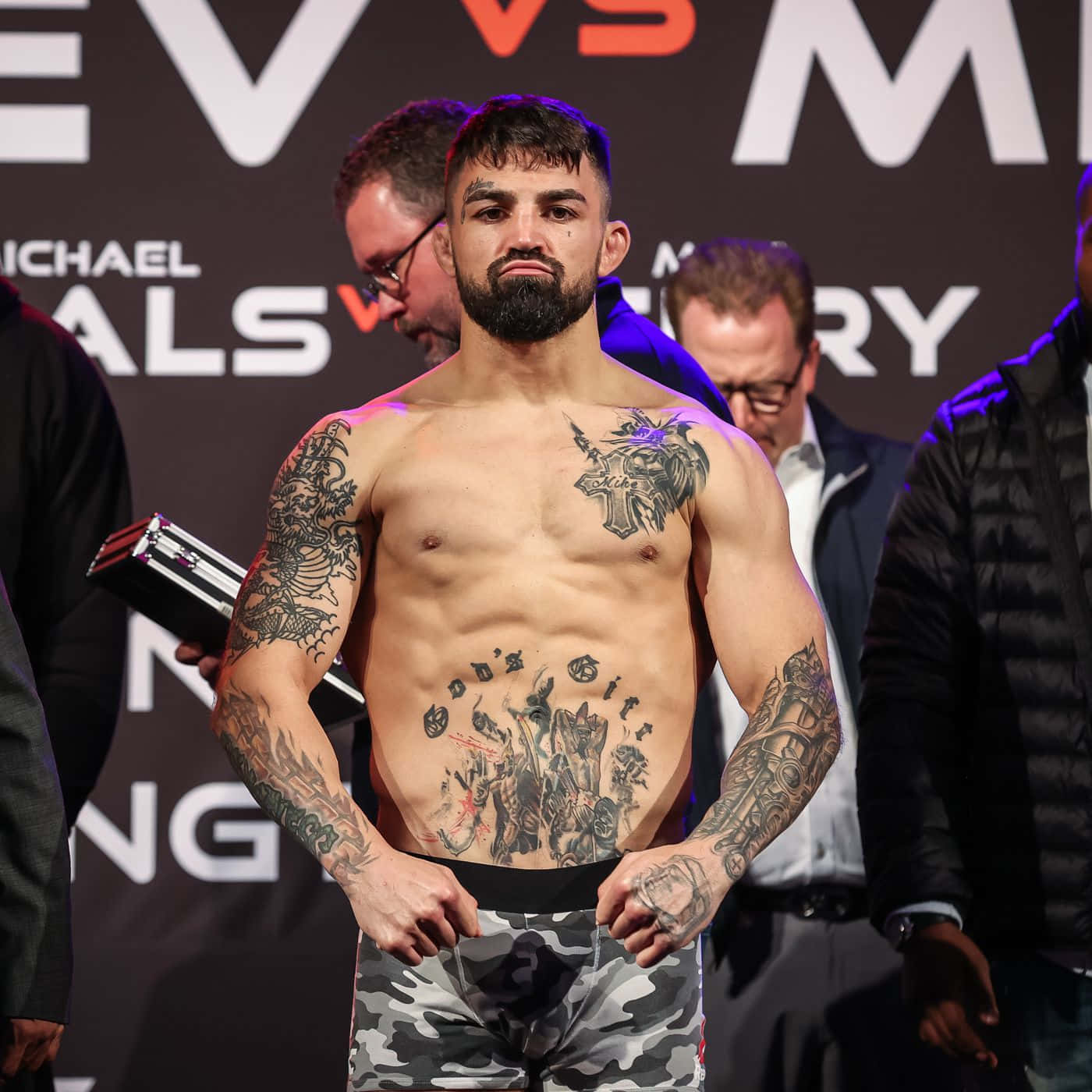 Mike Perry showing his abdomen and hand tattoos