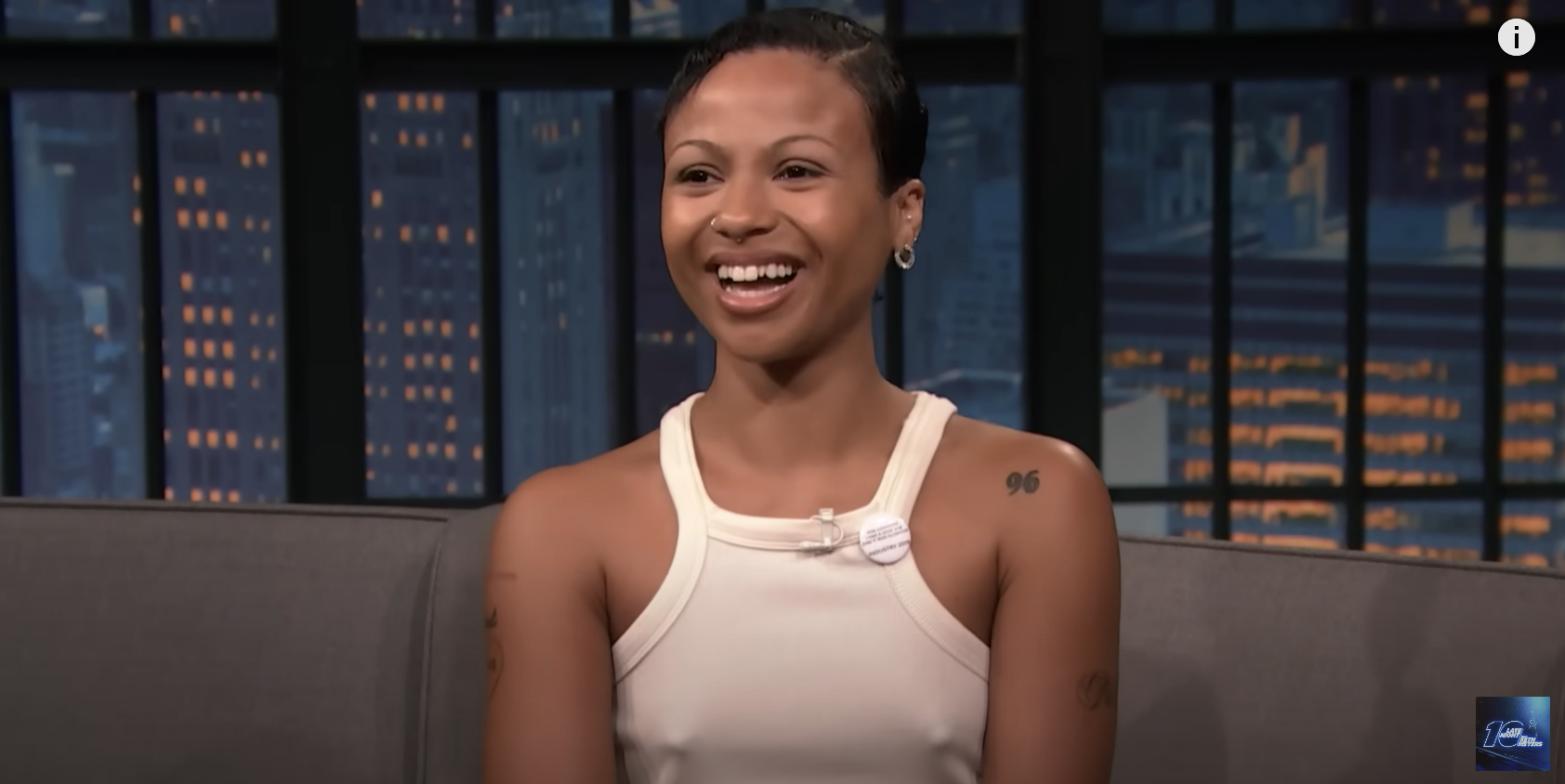 Myha'la tattoos: Interview still with the visible shoulder number and arm ink.