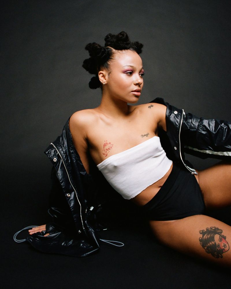 Myha'la tattoos: Tattoo photograph showing the shoulder number, chest lettering, and other visible ink.