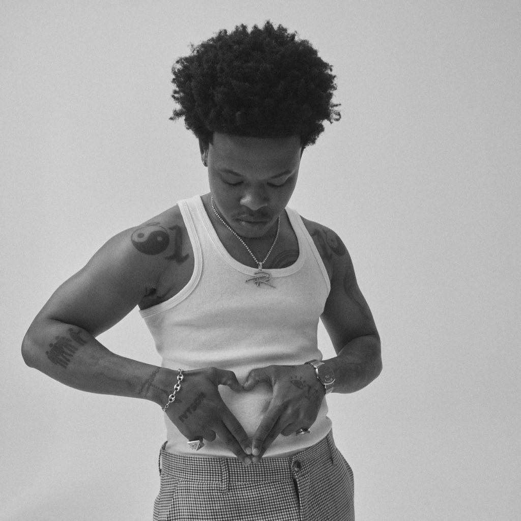 Nasty C tattoos: forearm, upper-arm and chest tattoos in a monochrome portrait