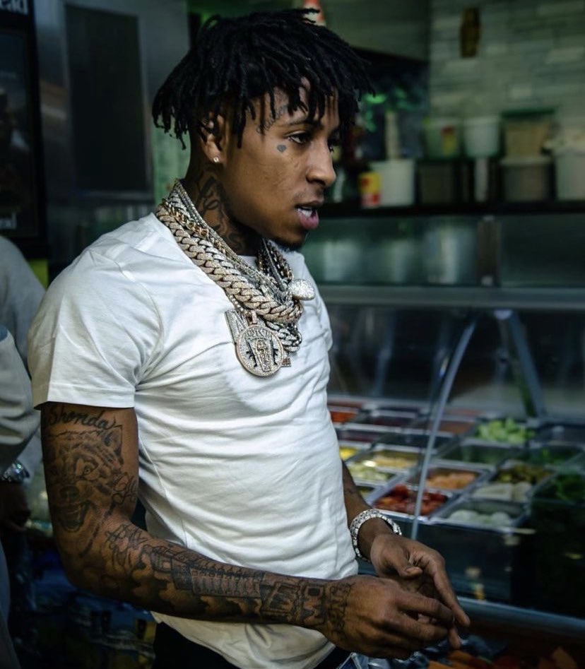 NBA YoungBoy’s arm tattoos, neck ink and face tattoo in a side portrait