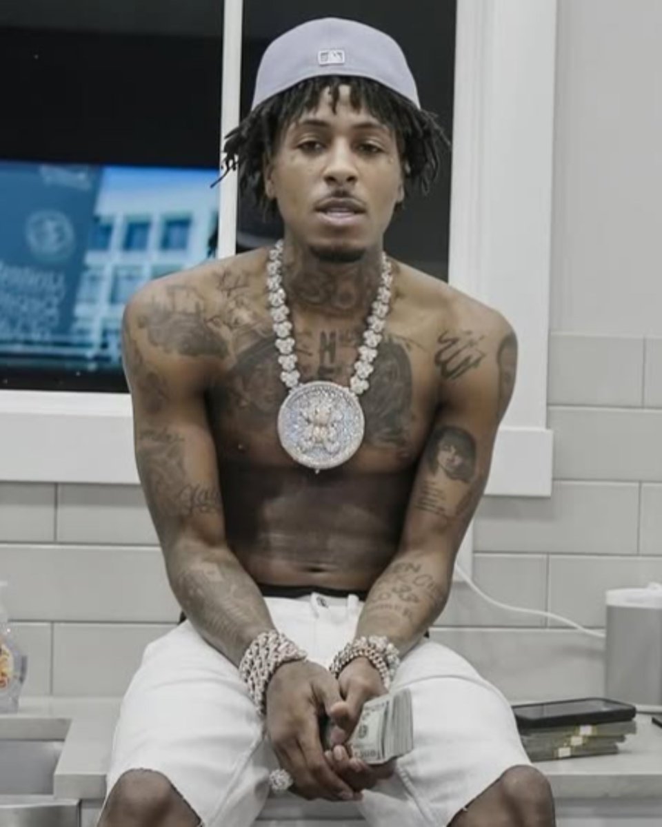 NBA YoungBoy chest and arm tattoos in a shirtless portrait
