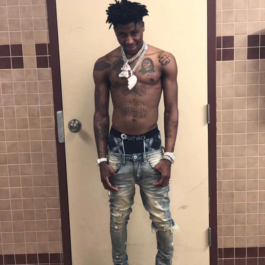 NBA YoungBoy chest portraits and torso tattoos in a full-body view
