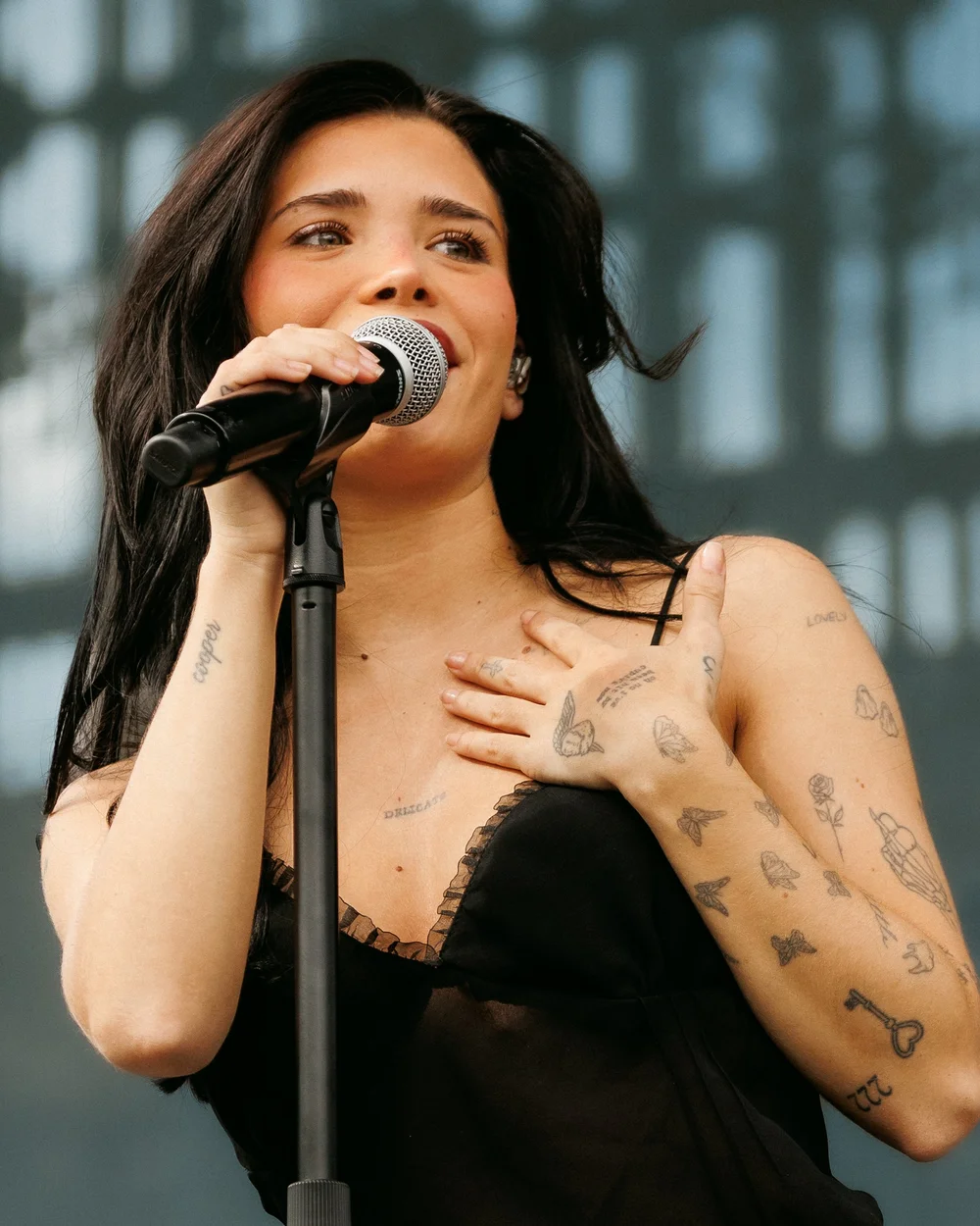 Nessa Barrett tattoos: arm lettering, butterflies, hand symbols, and wrist ink