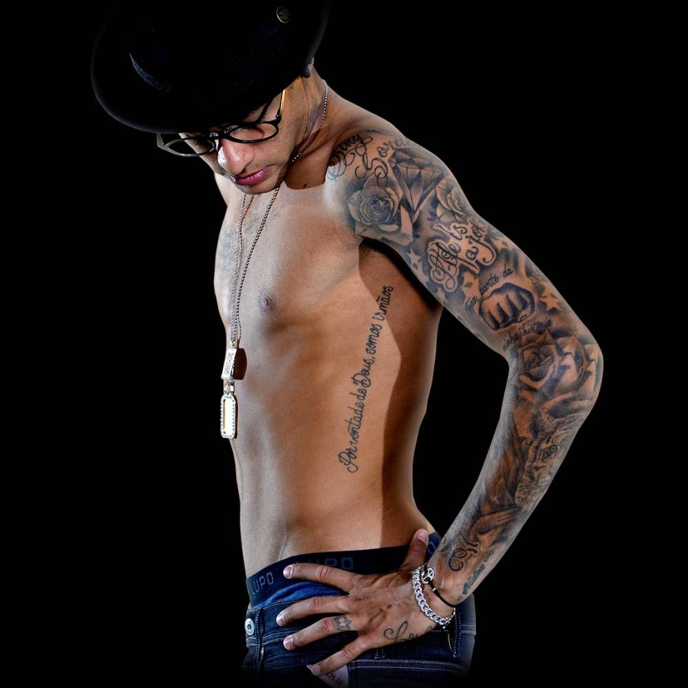 Neymar Jr tattoos: side view showing the full sleeve, roses, script and long rib lettering