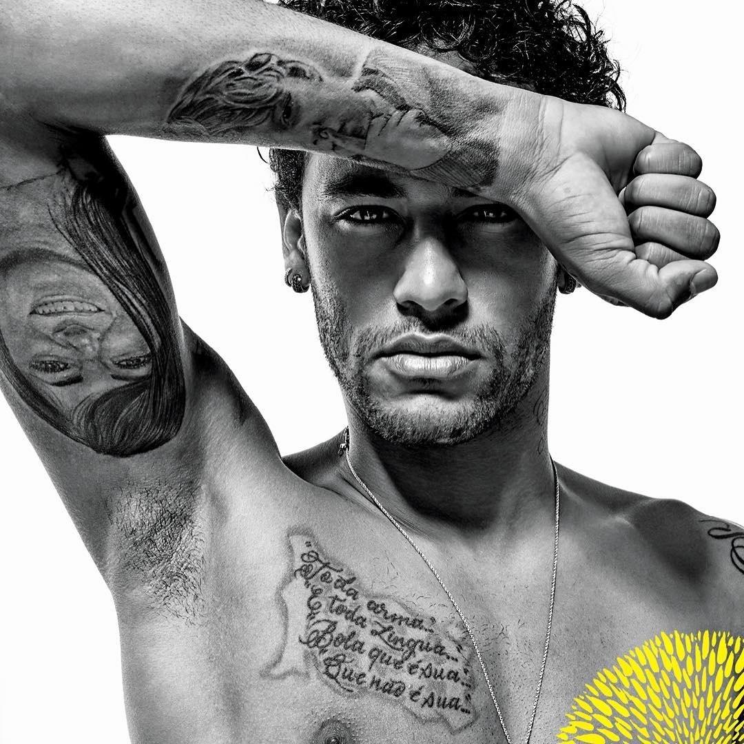 Neymar Jr tattoos: monochrome portrait showing the underarm portrait tattoo and chest lettering