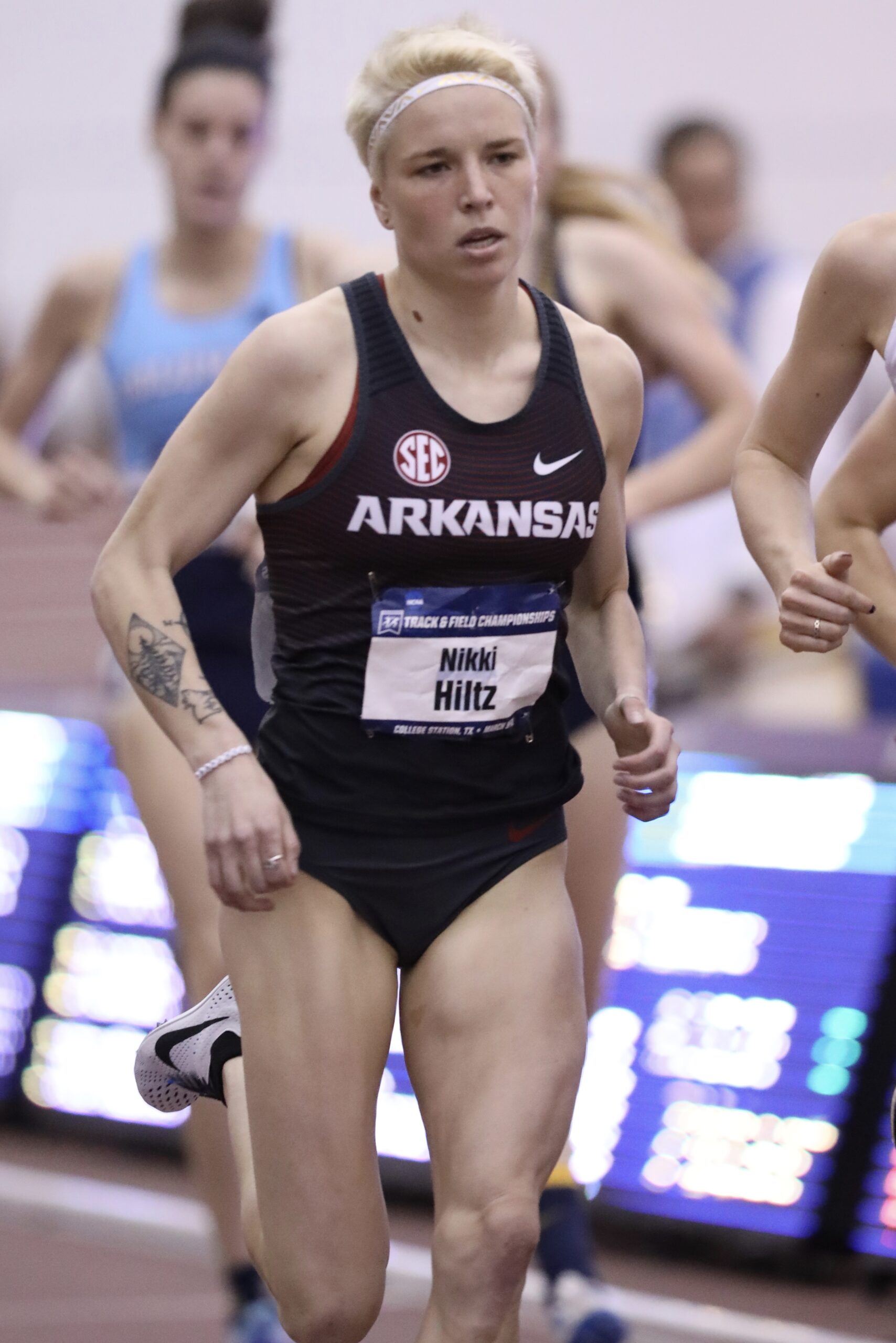 Nikki Hiltz Documented black-and-grey forearm coverage and smaller marks in an identifiable 2018 race photograph Nikki Hiltz tattoos: Documented black-and-grey forearm coverage and smaller marks in an identifiable 2018 race photograph