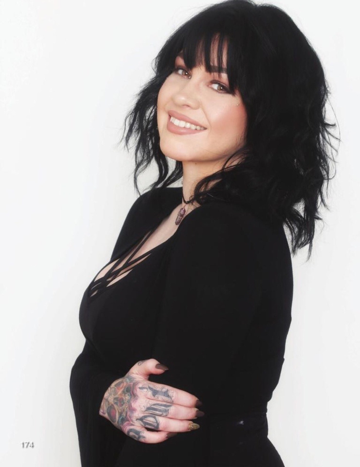 Nikki Simpson tattoos: face-visible portrait showing the contrast between Nikki's black outlines, colour fields, and sleeve details