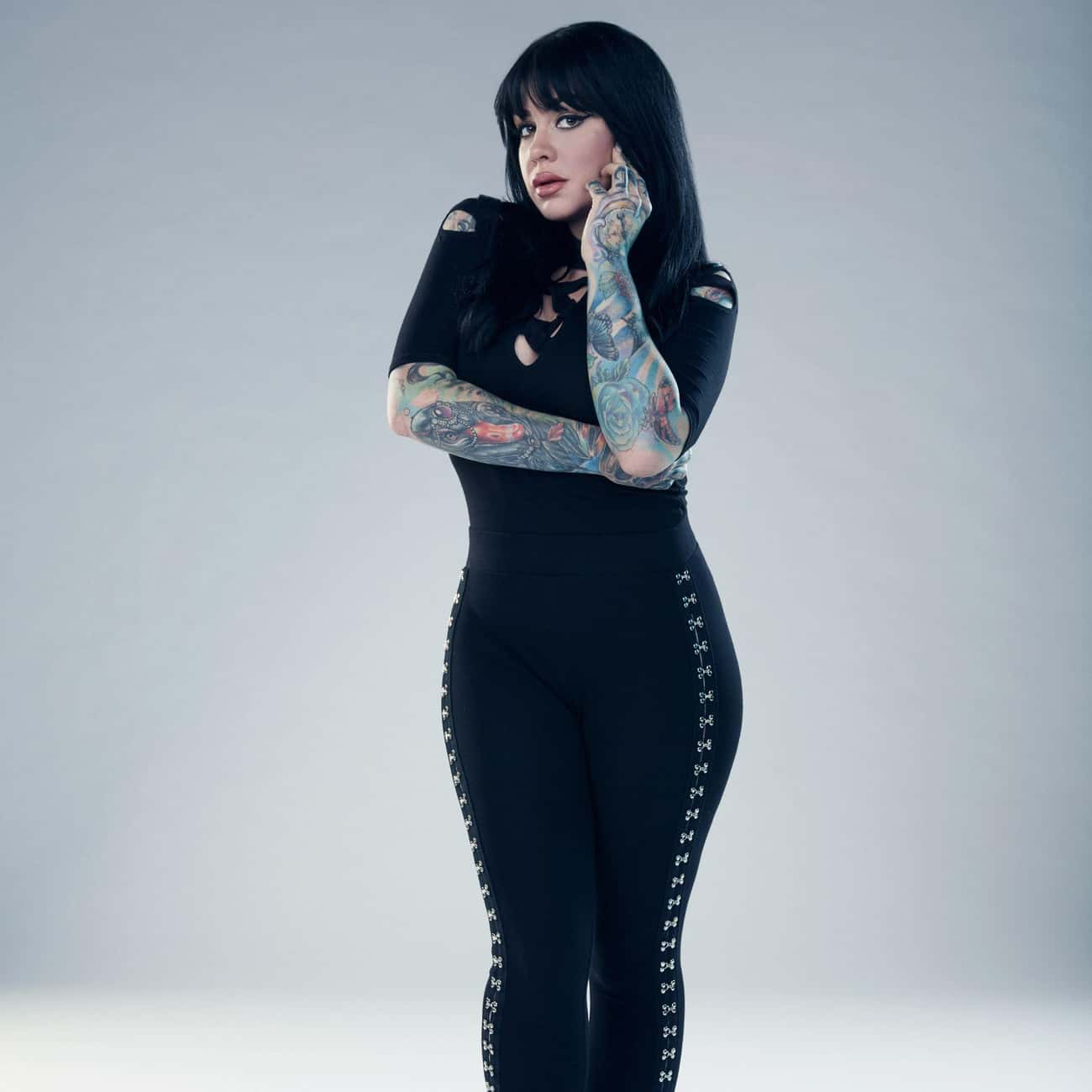 Nikki Simpson tattoos: face-visible portrait showing Nikki's forearm colour, sleeve flow, and hand coverage clearly