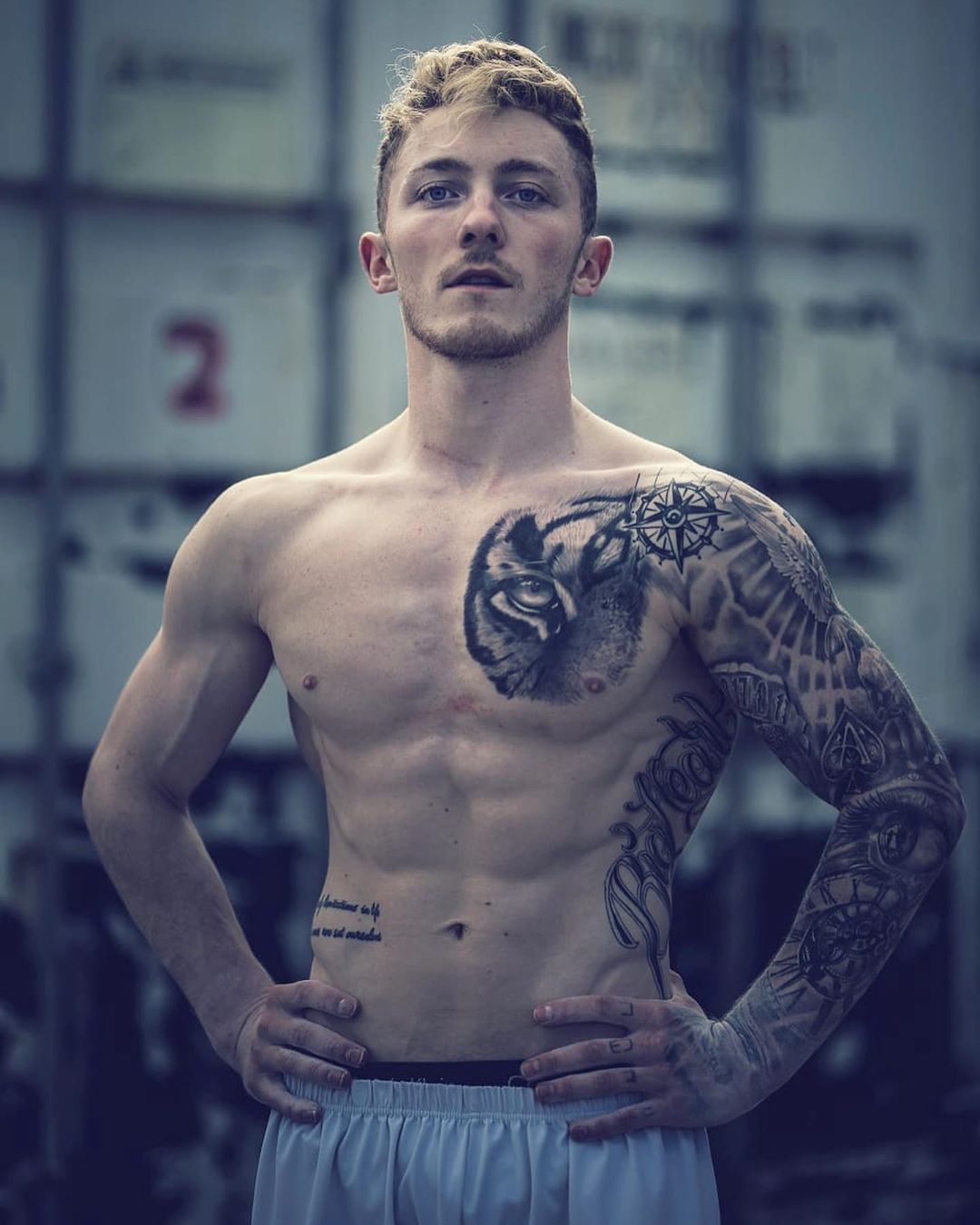 Nile Wilson tattoos: face-visible portrait showing the tiger eye chest tattoo and compass