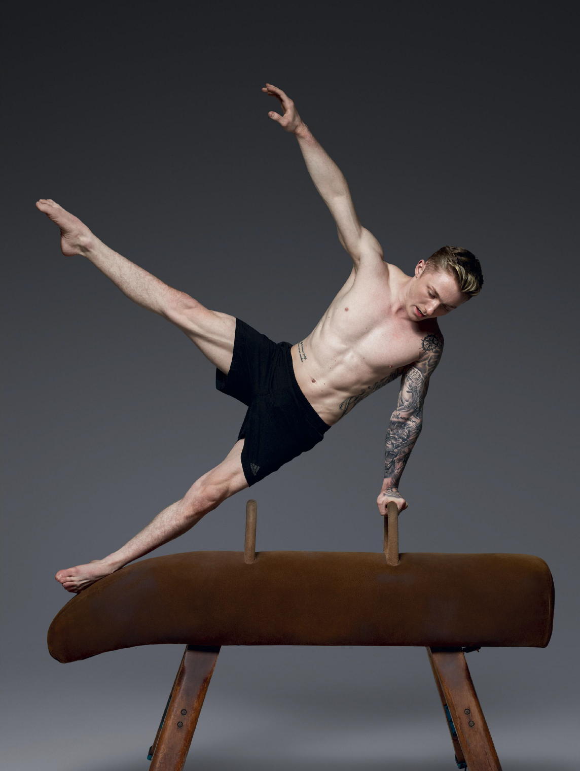 Nile Wilson tattoos: full-body gymnastics portrait showing the sleeve wrapping through movement