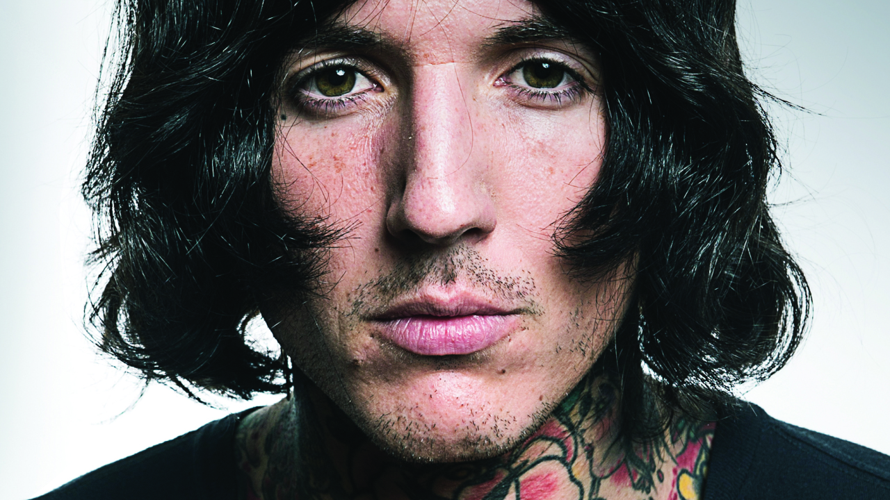 Oliver Sykes in an earlier portrait, with his neck tattoos visible.