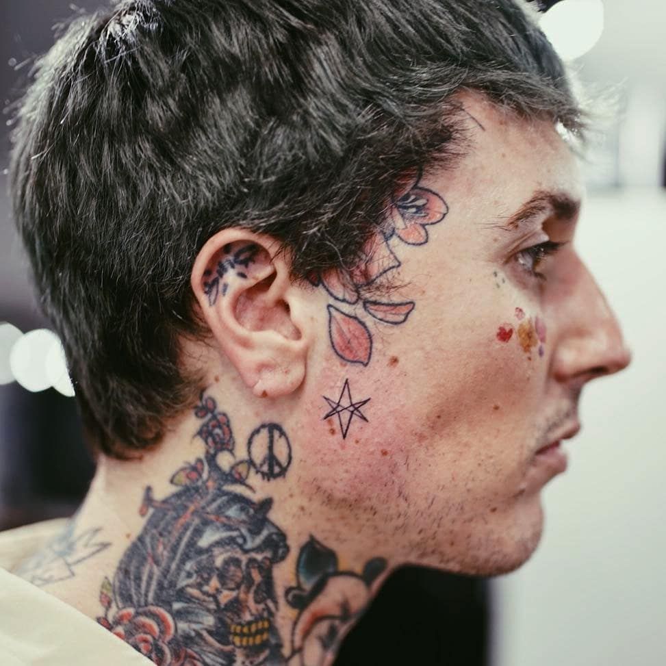 Oli Sykes rose and side neck tattoos