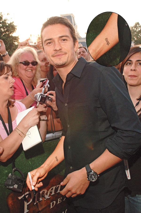 Orlando Bloom tattoos: Elvish nine wrist tattoo shown at a public appearance