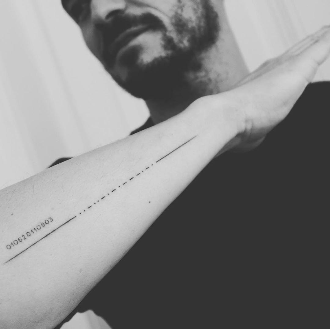 Orlando Bloom tattoos: Morse code forearm tattoo for his son