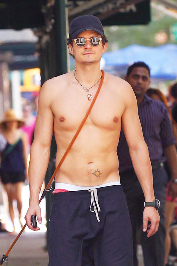 Orlando Bloom tattoos: small sun tattoo on the lower left abdomen