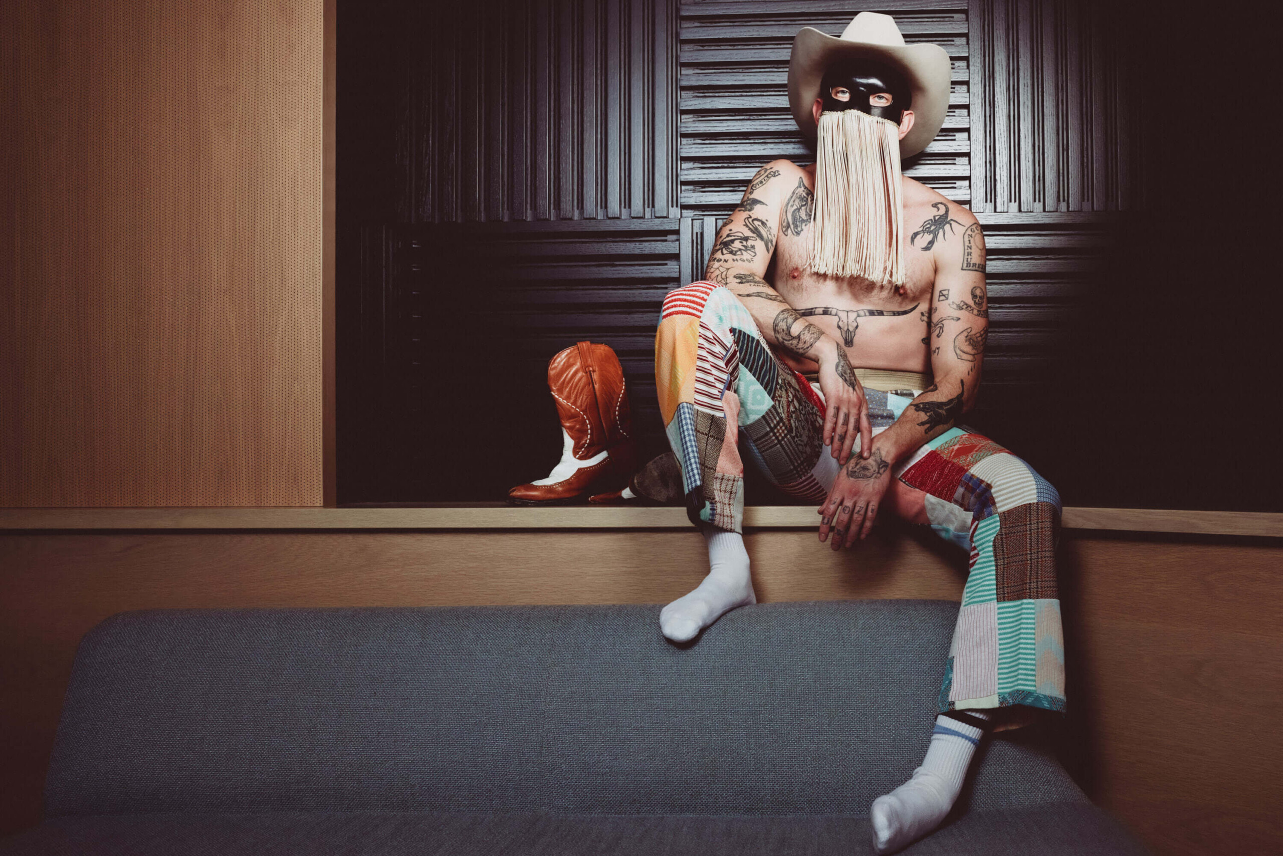 Orville Peck tattoos: clear arm and chest tattoo photograph