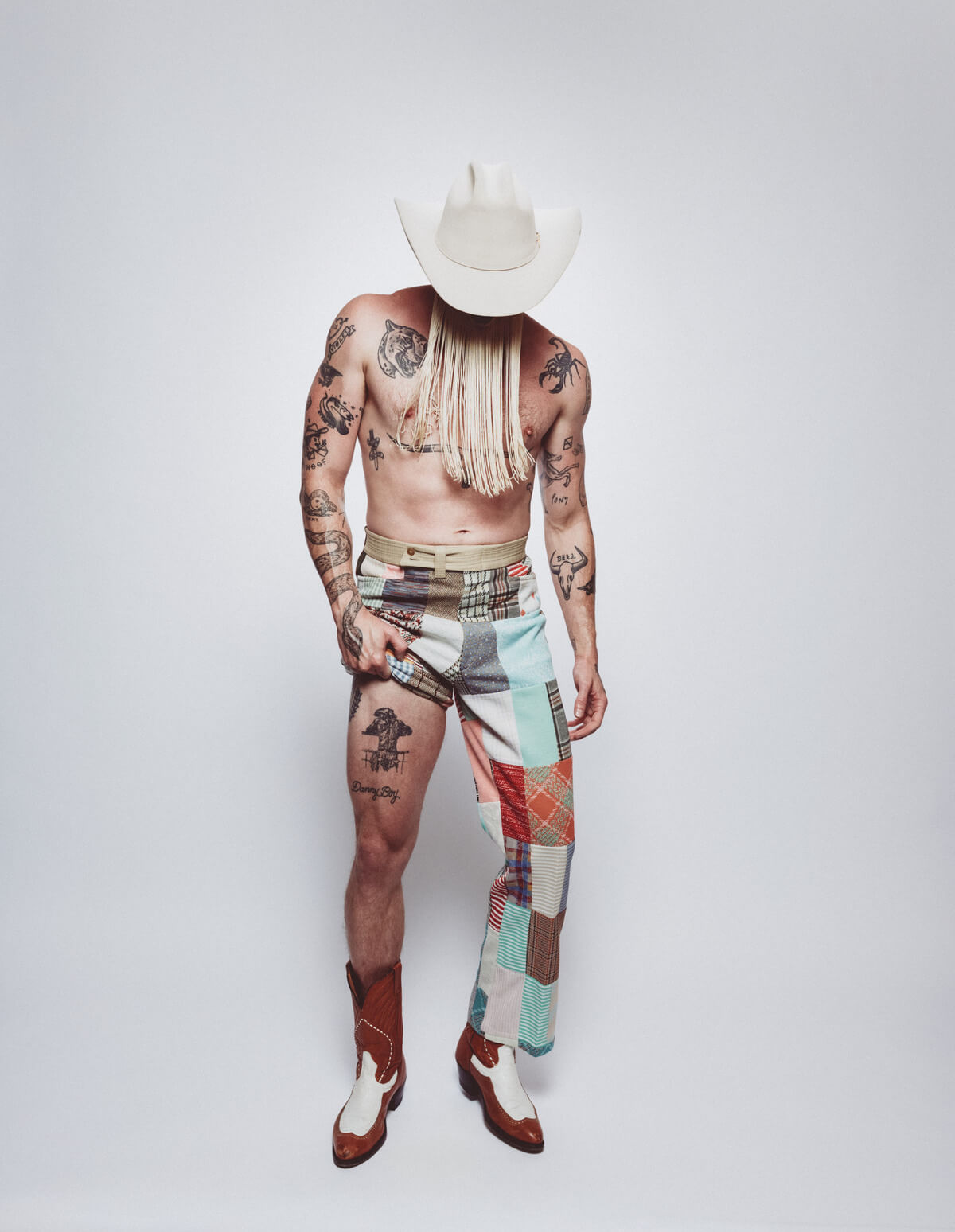 Orville Peck tattoos: full-length tattoo photograph showing the wider animal collection