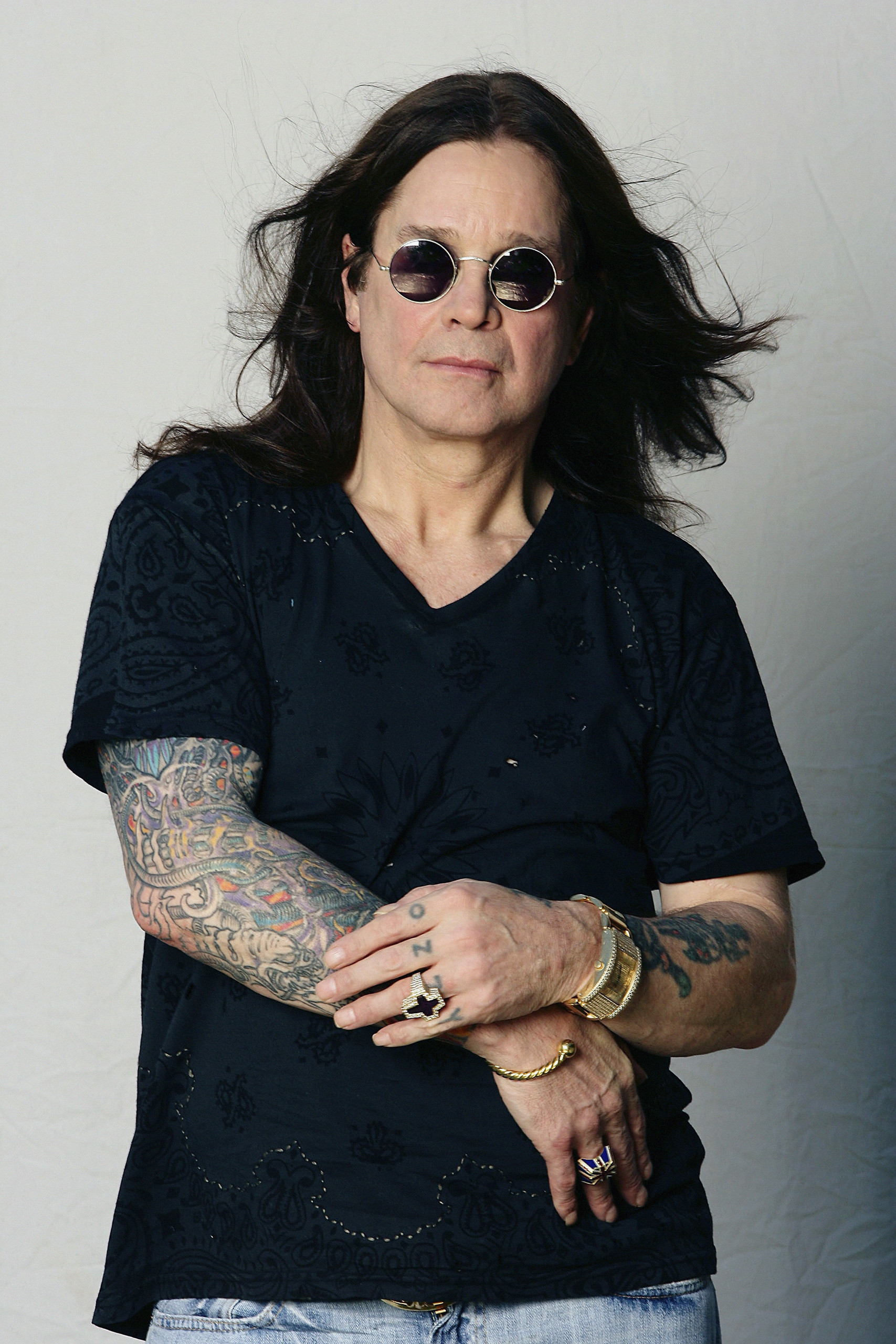Ozzy Osbourne colorful arm tattoos and sleeve work visible in a portrait