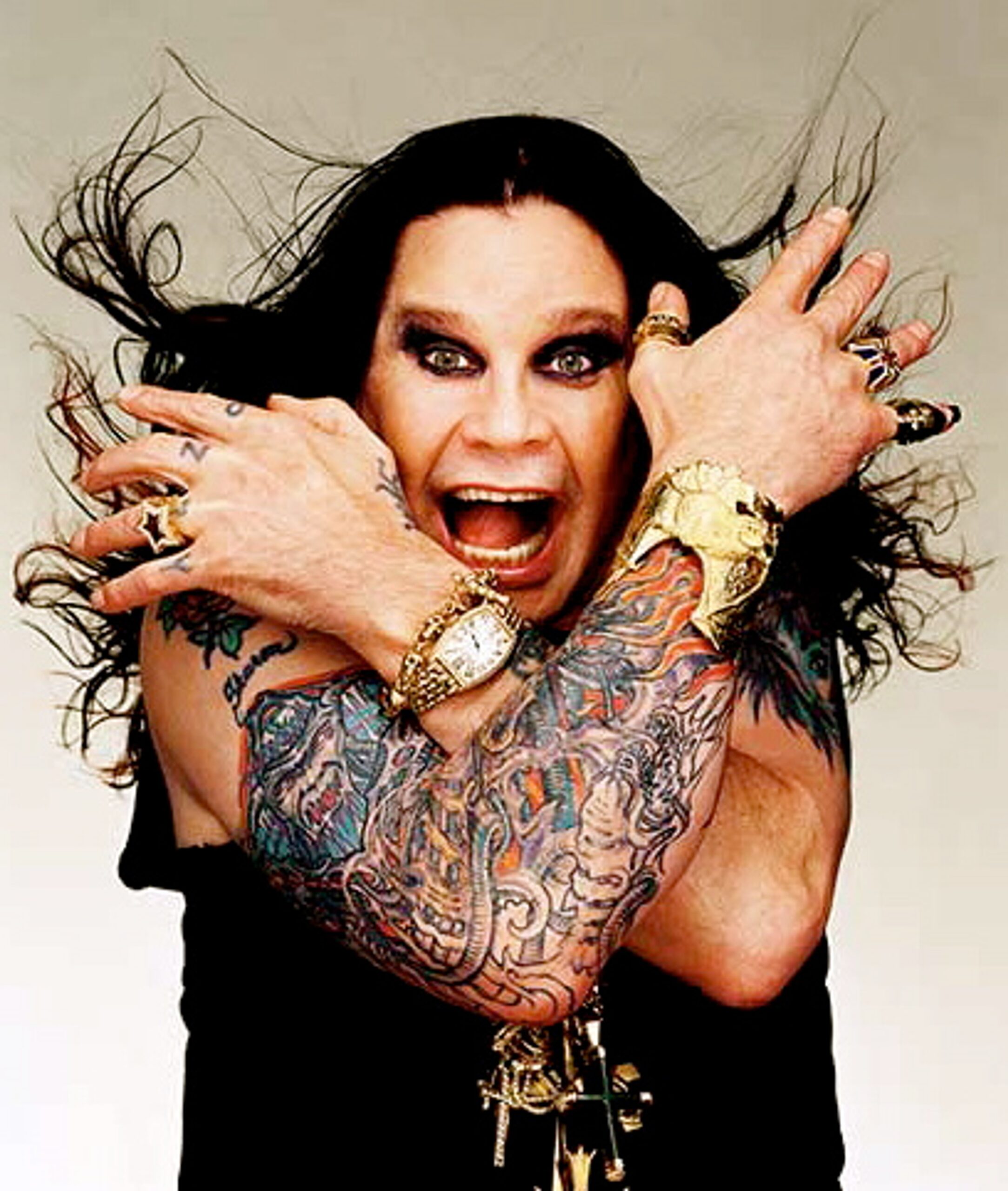 Ozzy Osbourne dragon, flames and claw sleeve tattoo visible in a portrait