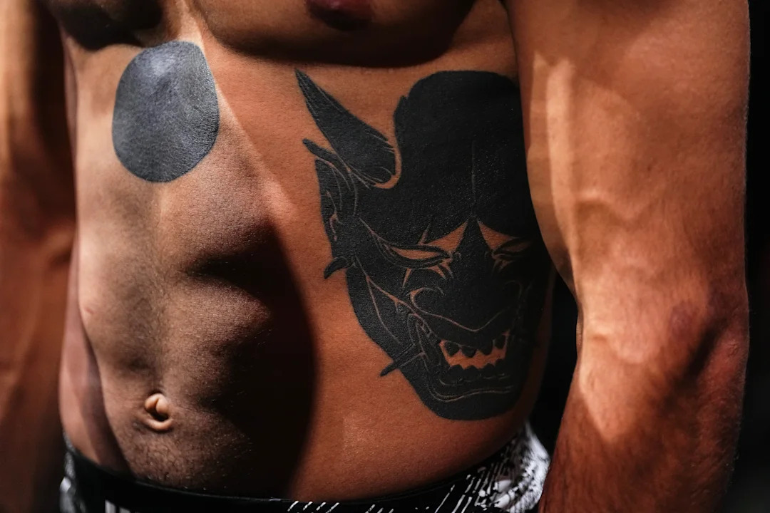 Payton Talbott tattoos: The black circle below his chest