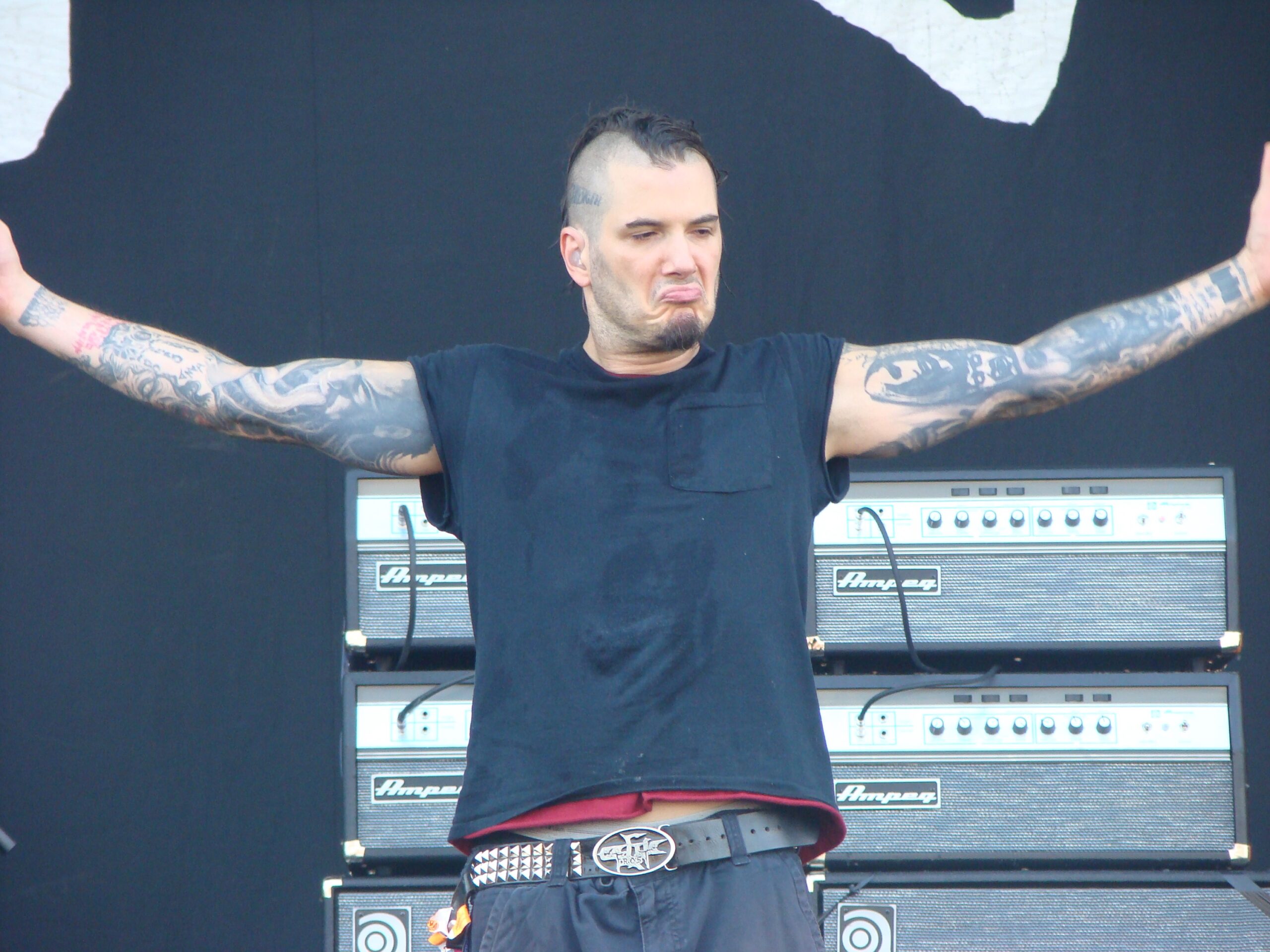 Phil Anselmo full sleeve tattoos with both arms raised