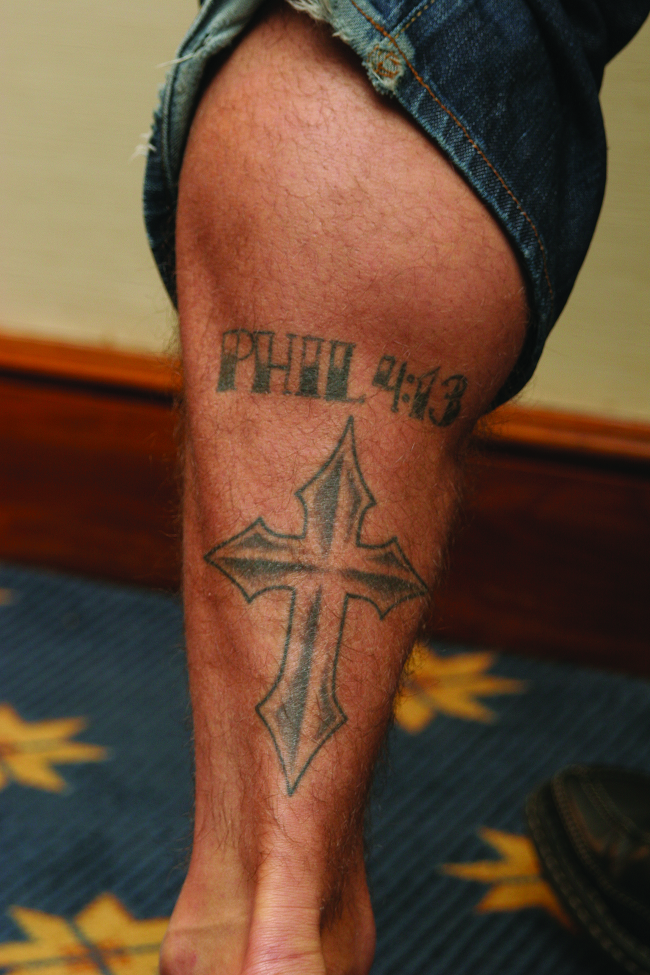 Phil Baroni tattoos: Cross and Philippians tattoo on his left calf