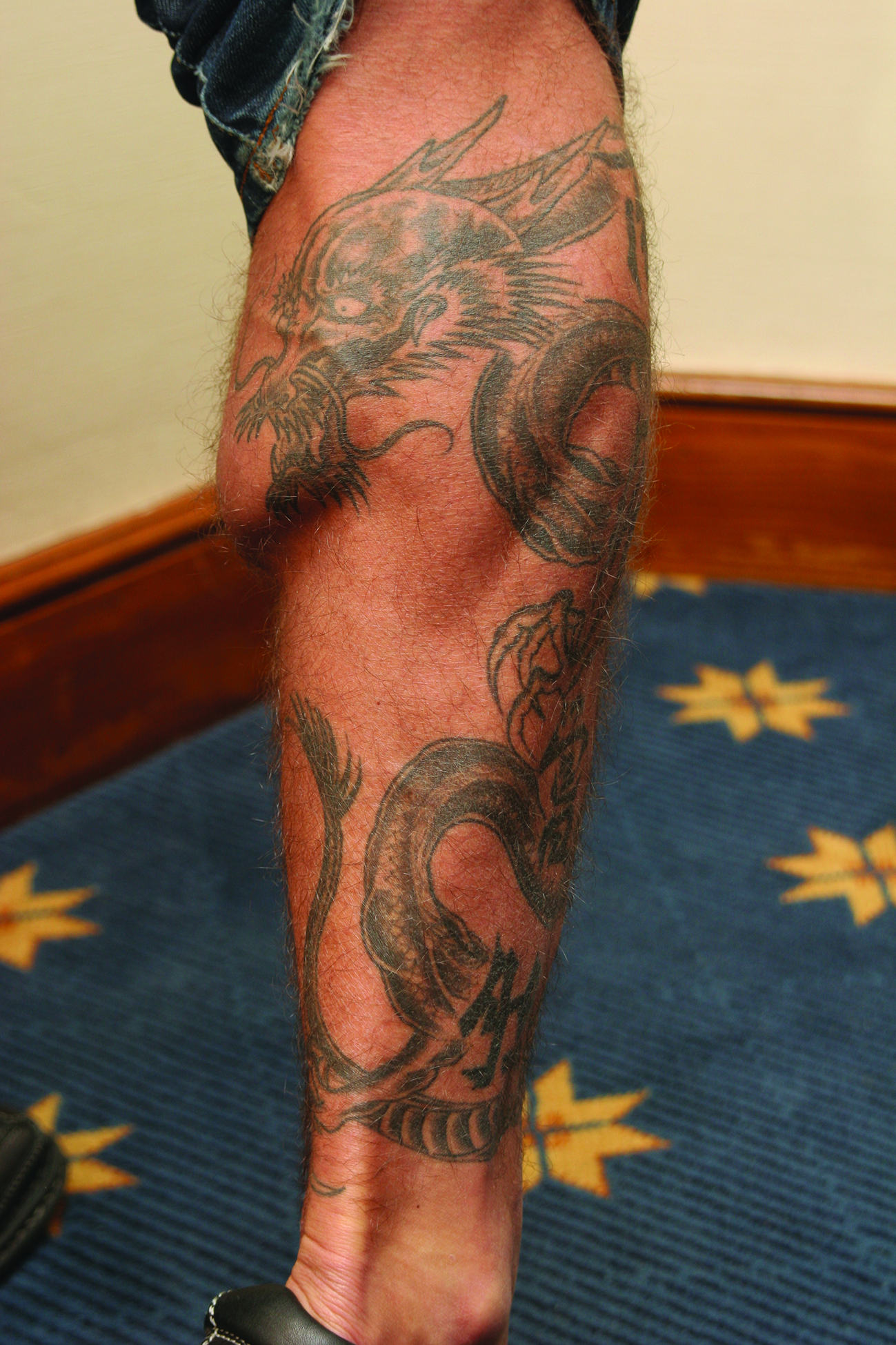 Phil Baroni tattoos: Dragon tattoo on his right calf
