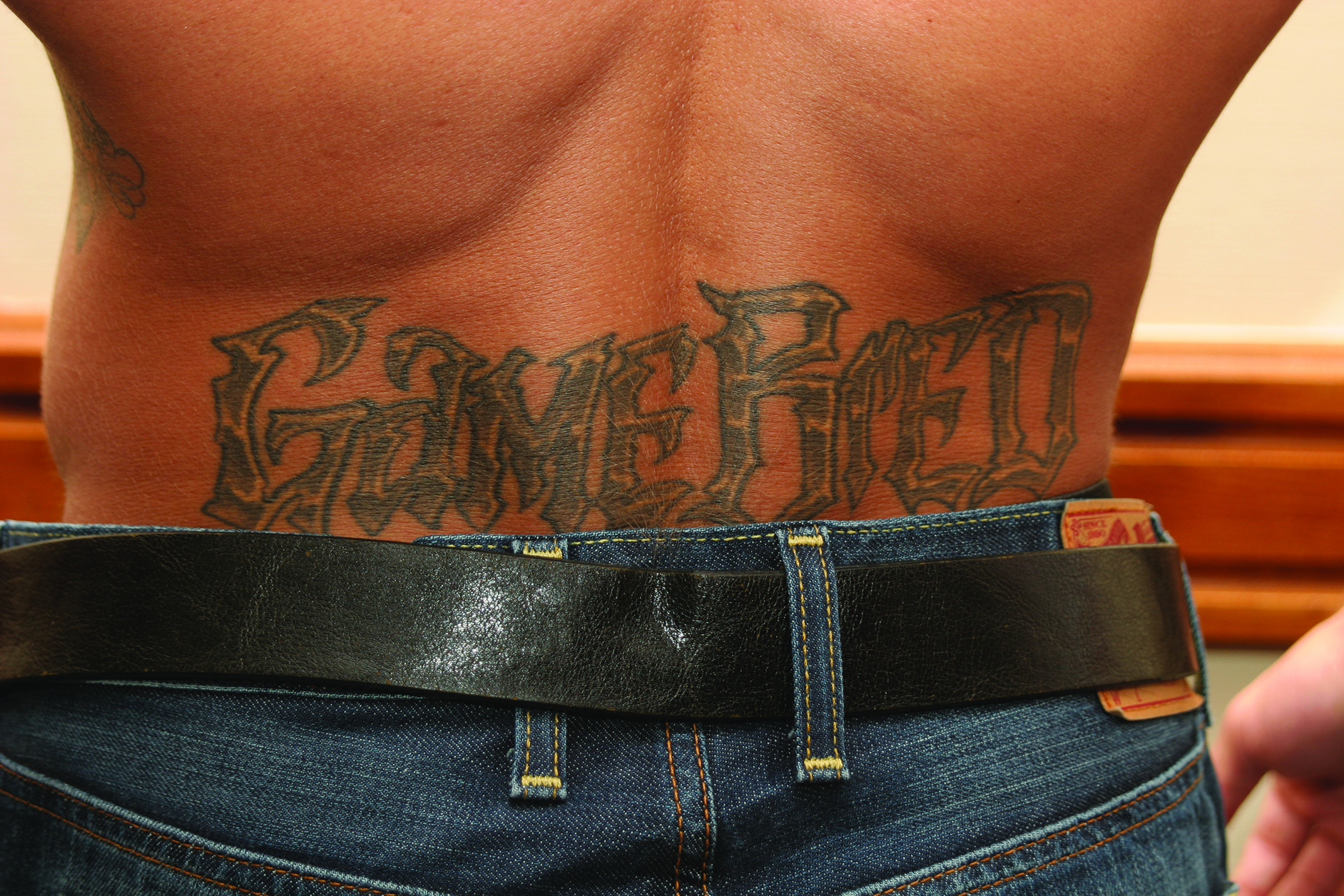 Phil Baroni tattoos: Gamebred lettering across his lower back