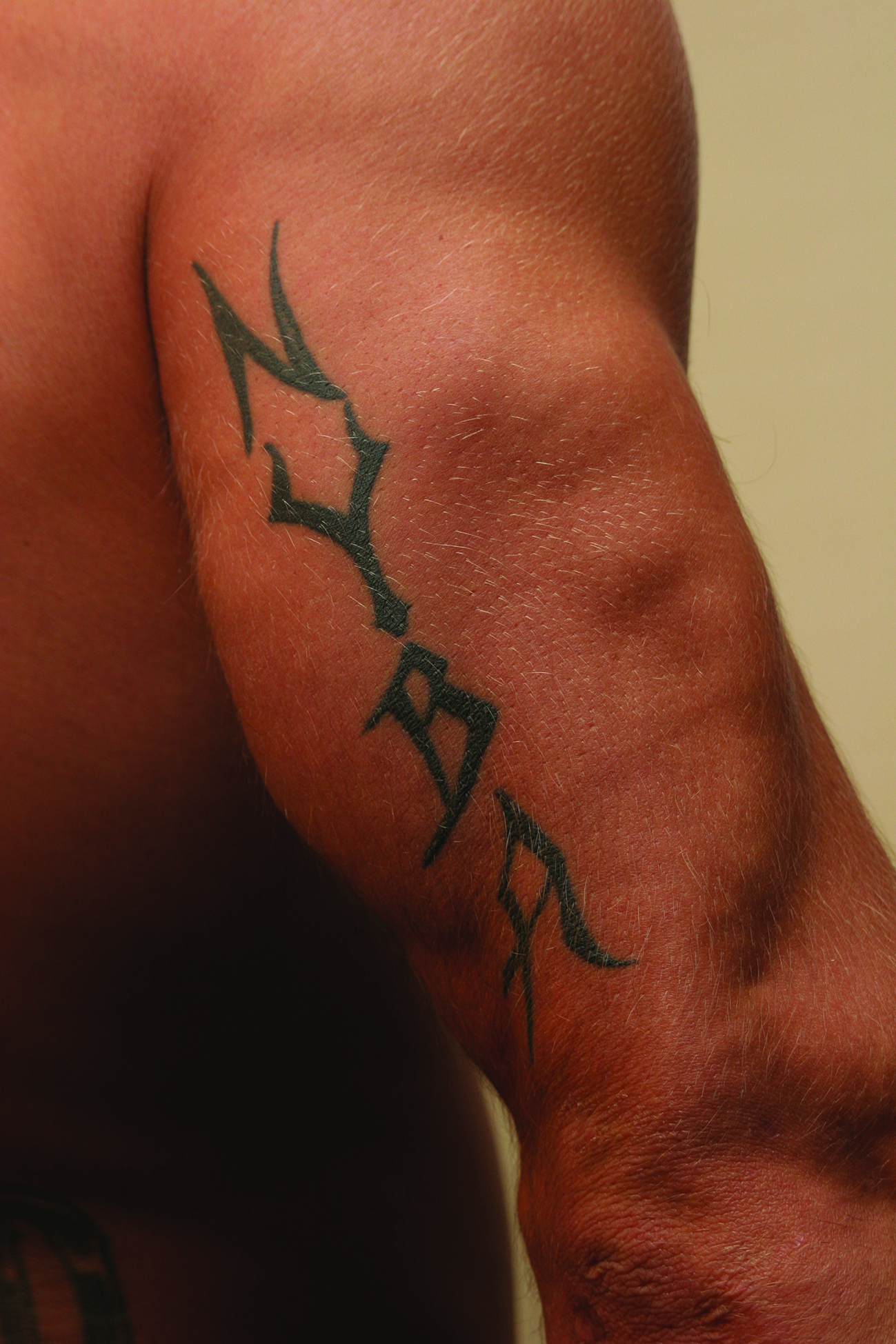 Phil Baroni tattoos: NYBA tattoo on his right arm