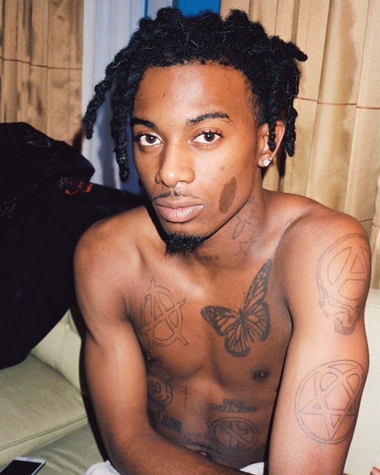 Playboi Carti butterfly chest tattoo