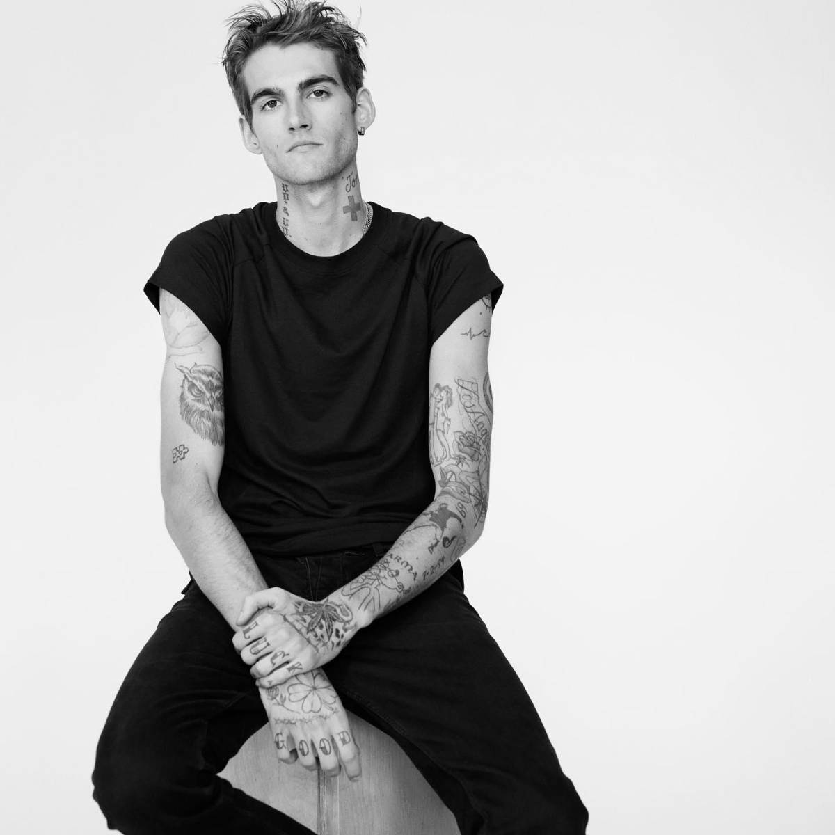 Presley Gerber tattoos: face-visible portrait with neck, arm, and hand tattoos