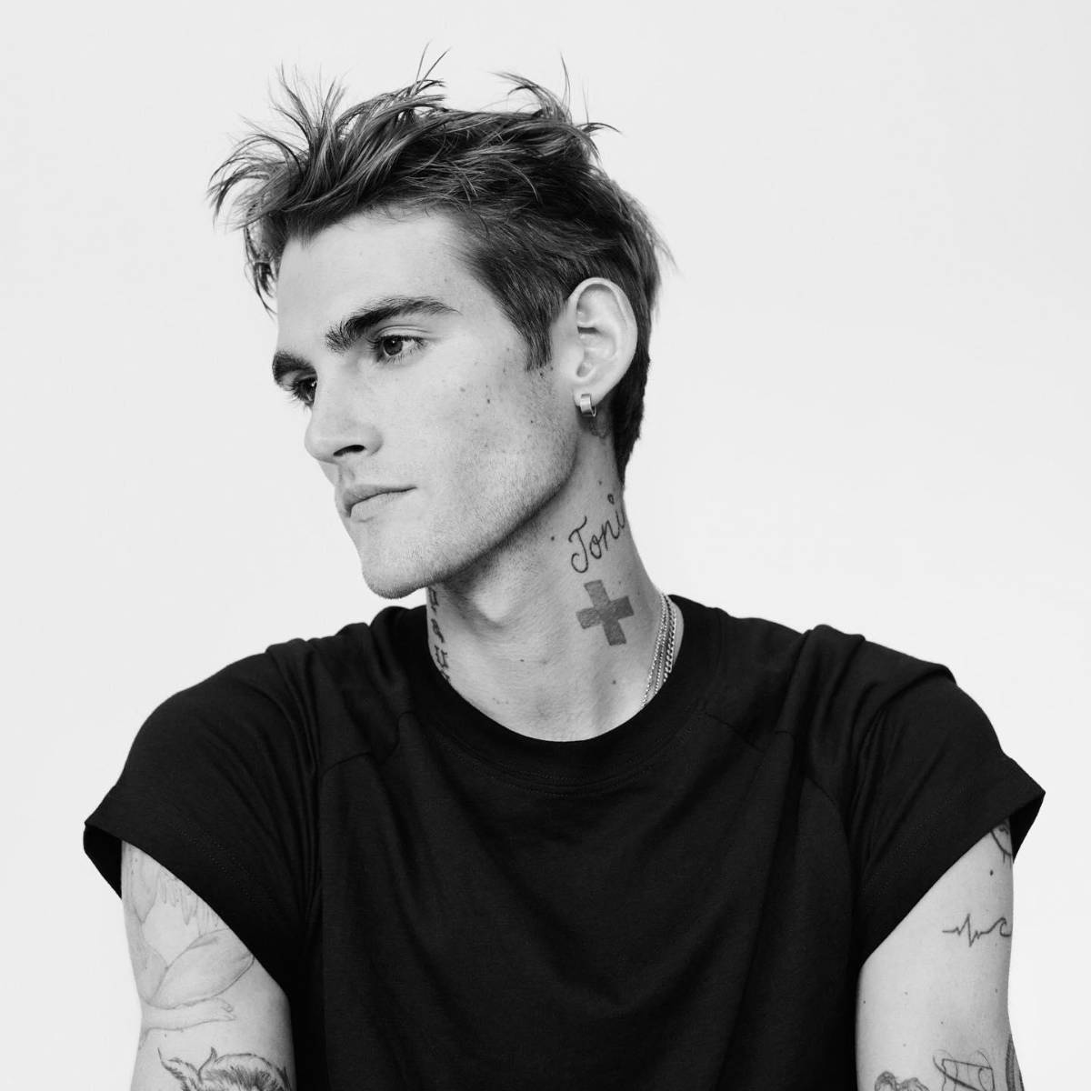 Presley Gerber tattoos: neck cross, script, and arm tattoo details