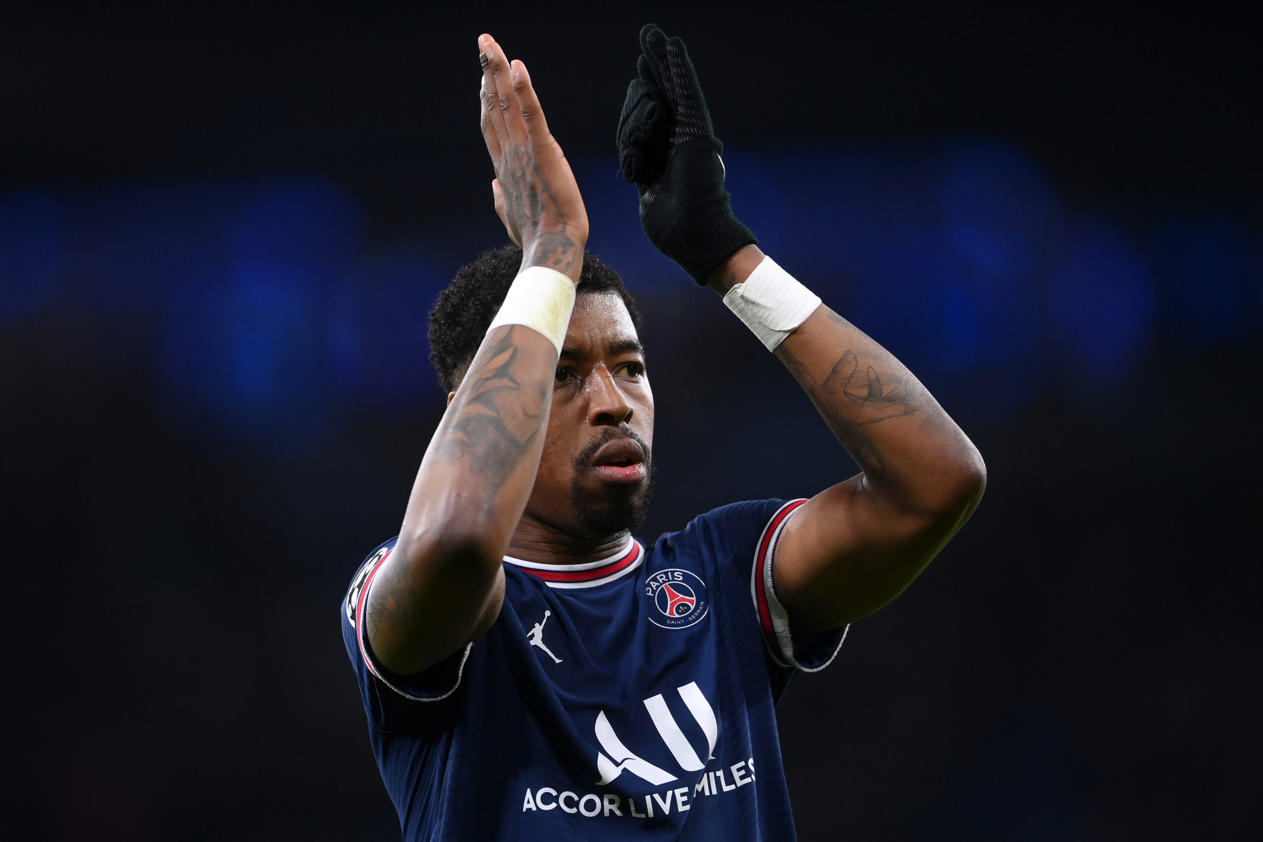 Presnel Kimpembe tattoos: High-resolution PSG match photograph showing hand, wrist, forearm and upper-arm ink