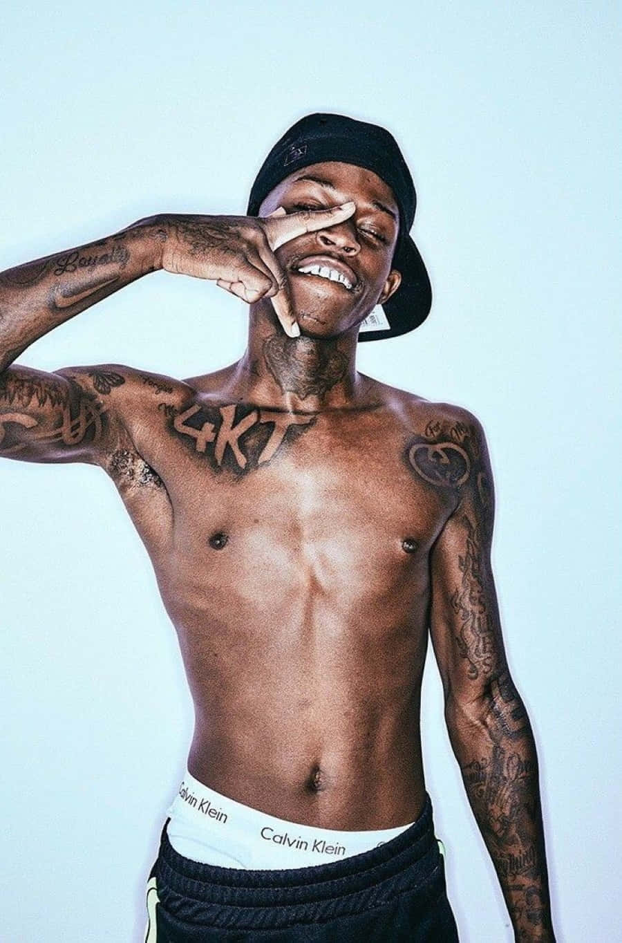 Quando Rondo tattoos: large chest lettering and upper-torso ink