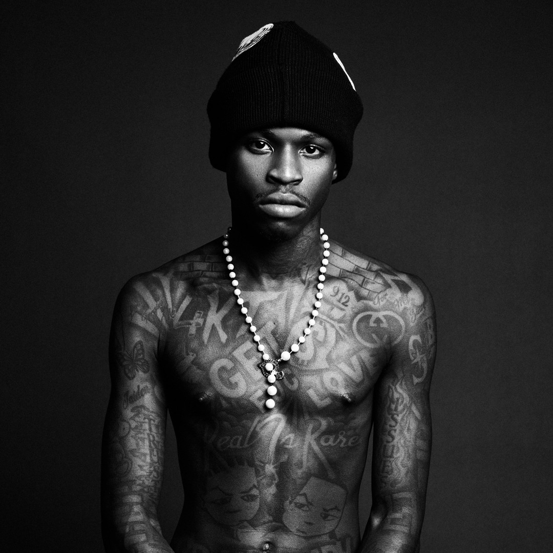 Quando Rondo tattoos: dense arm sleeve lettering and symbols