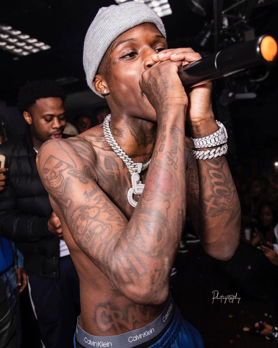 Quando Rondo tattoos: hand and wrist tattoos visible while performing