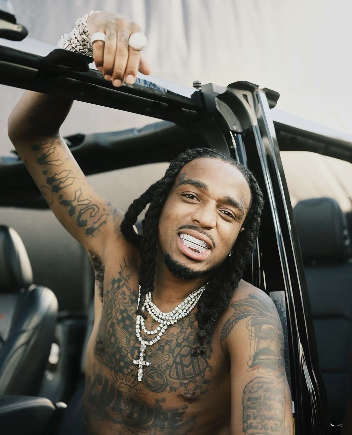 Quavo chest, arm and hand tattoos