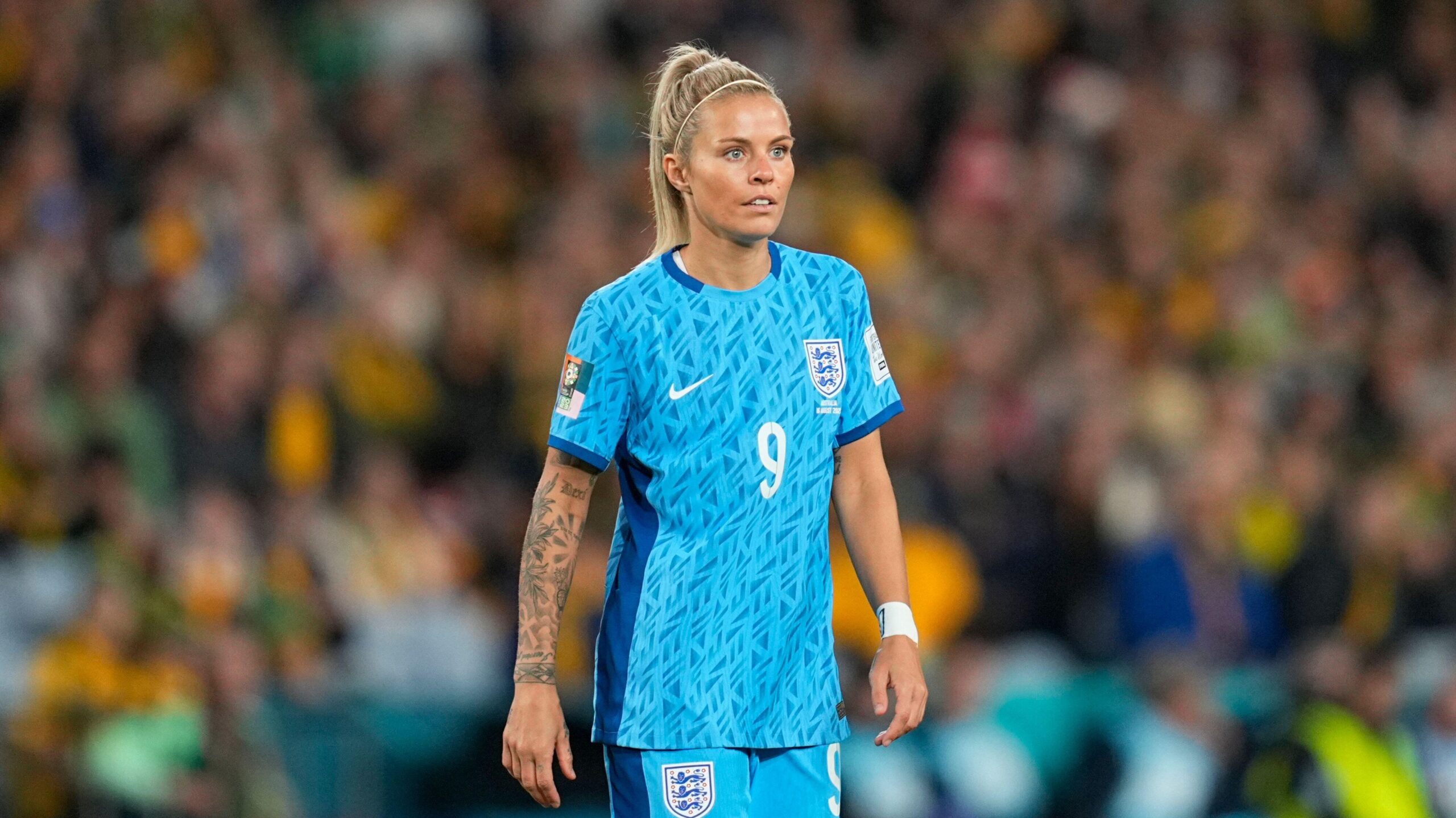 Rachel Daly tattoos: the long forearm design and smaller wrist details in a match portrait