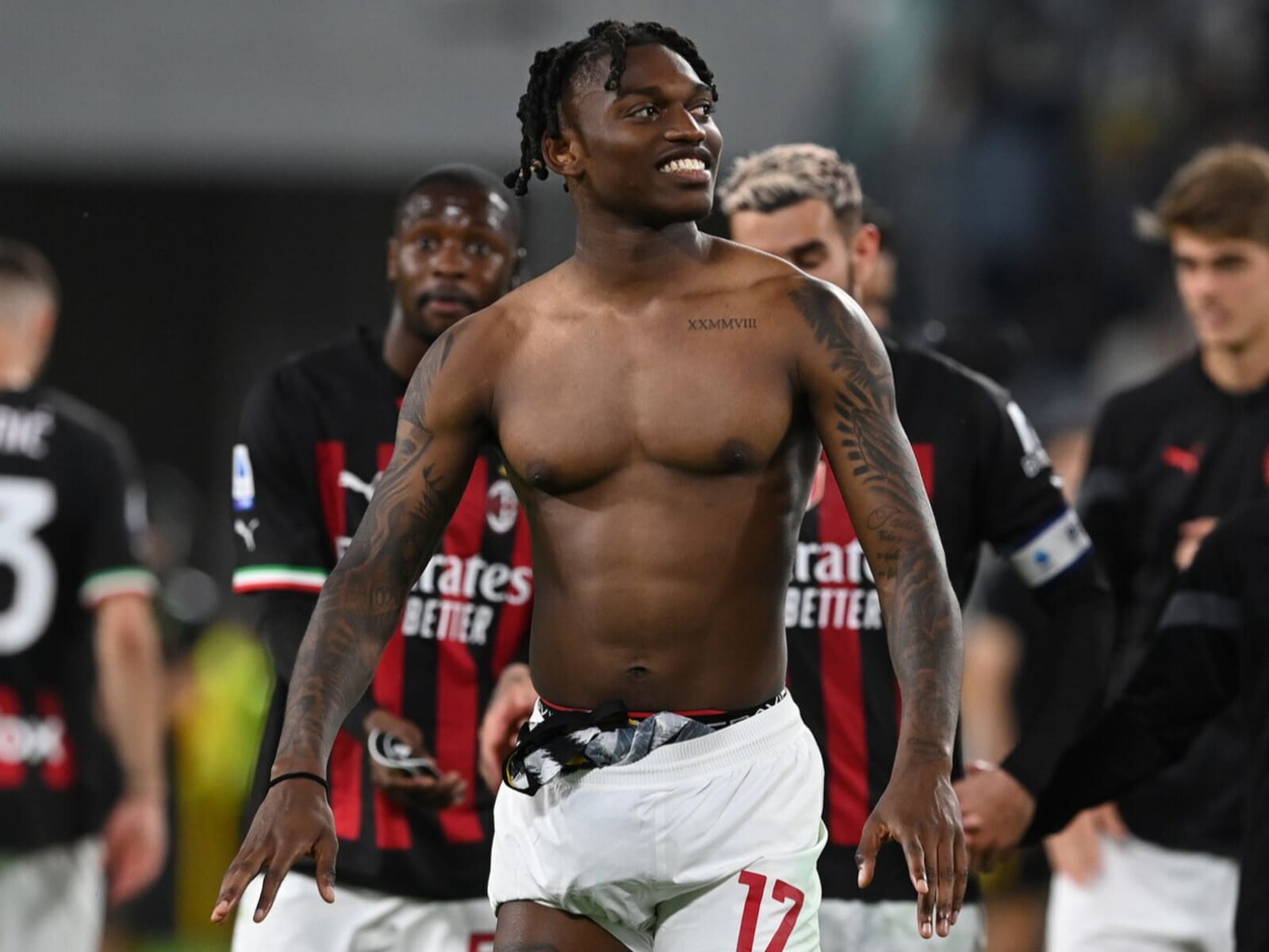 Rafael Leao tattoos: Distinct post-match photograph showing the arm and torso tattoo coverage in context