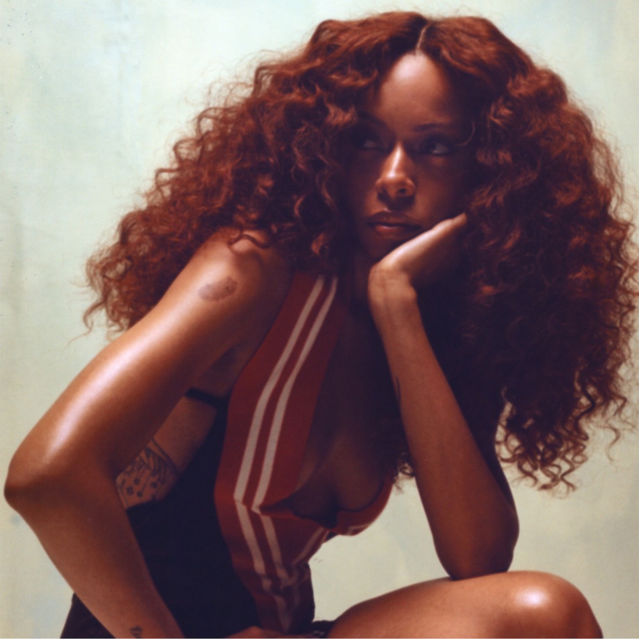 Ravyn Lenae small upper-arm tattoo
