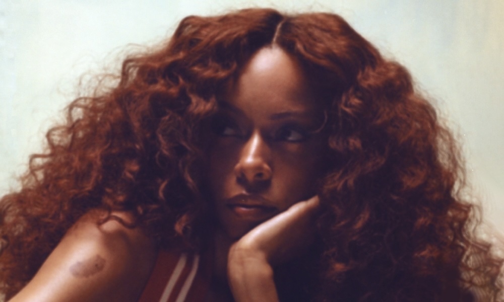 Ravyn Lenae tattoo visible in a wider portrait
