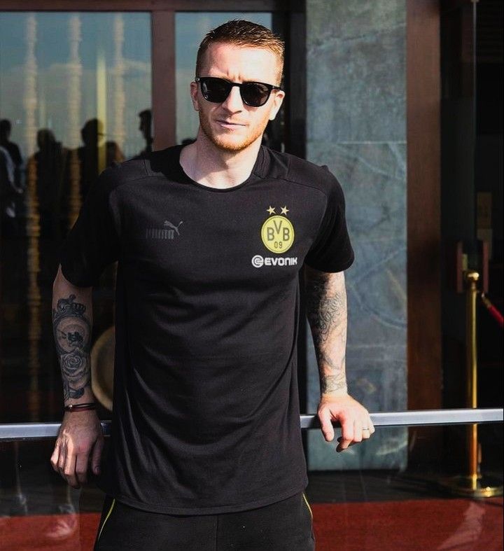 Marco Reus tattoos on both forearms in a Borussia Dortmund photo