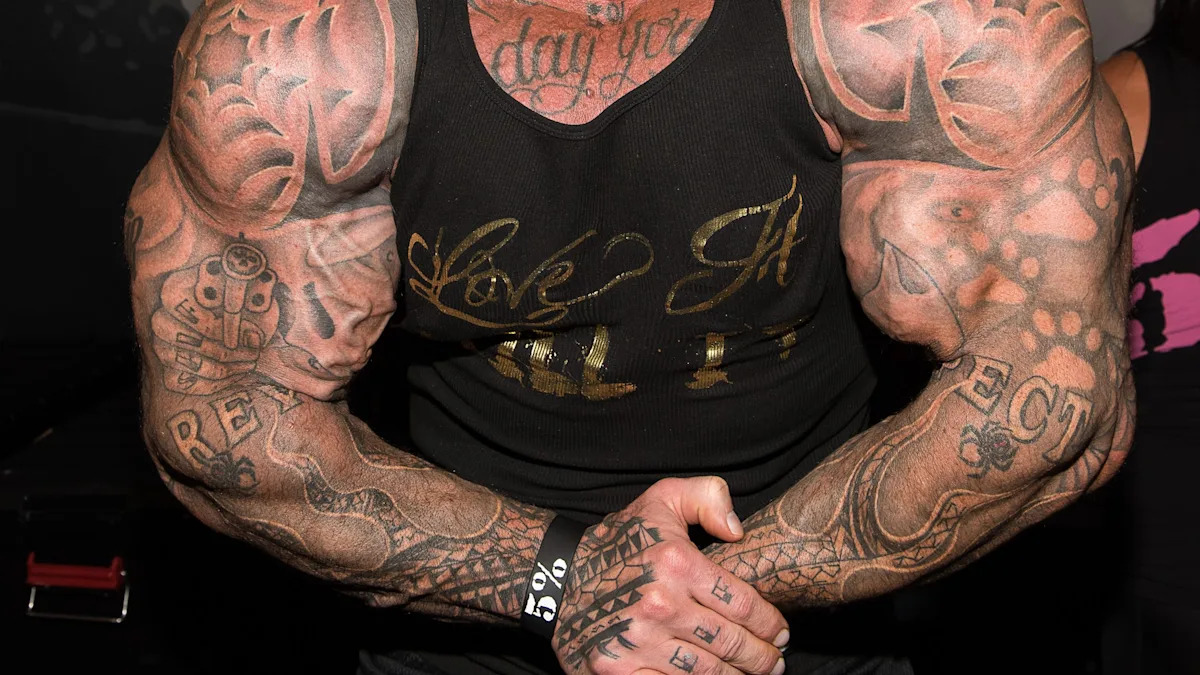 Rich Piana tattoos: high-resolution torso and arm view where the revolver motif, lettering, and forearm coverage are easy to inspect