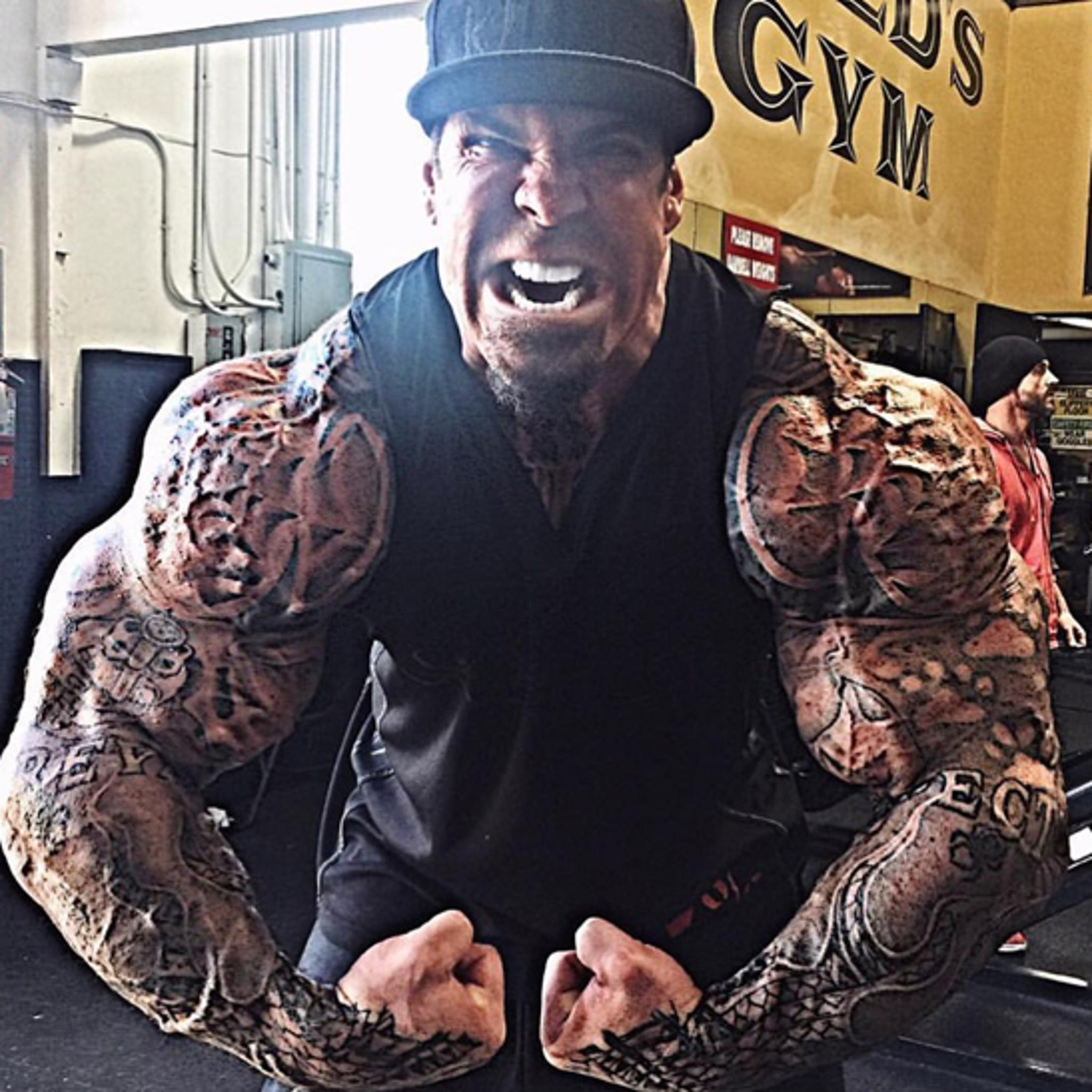 Rich Piana tattoos: clear face-visible front view showing Rich Piana's dense shoulder and upper-arm tattoos following the muscle shape