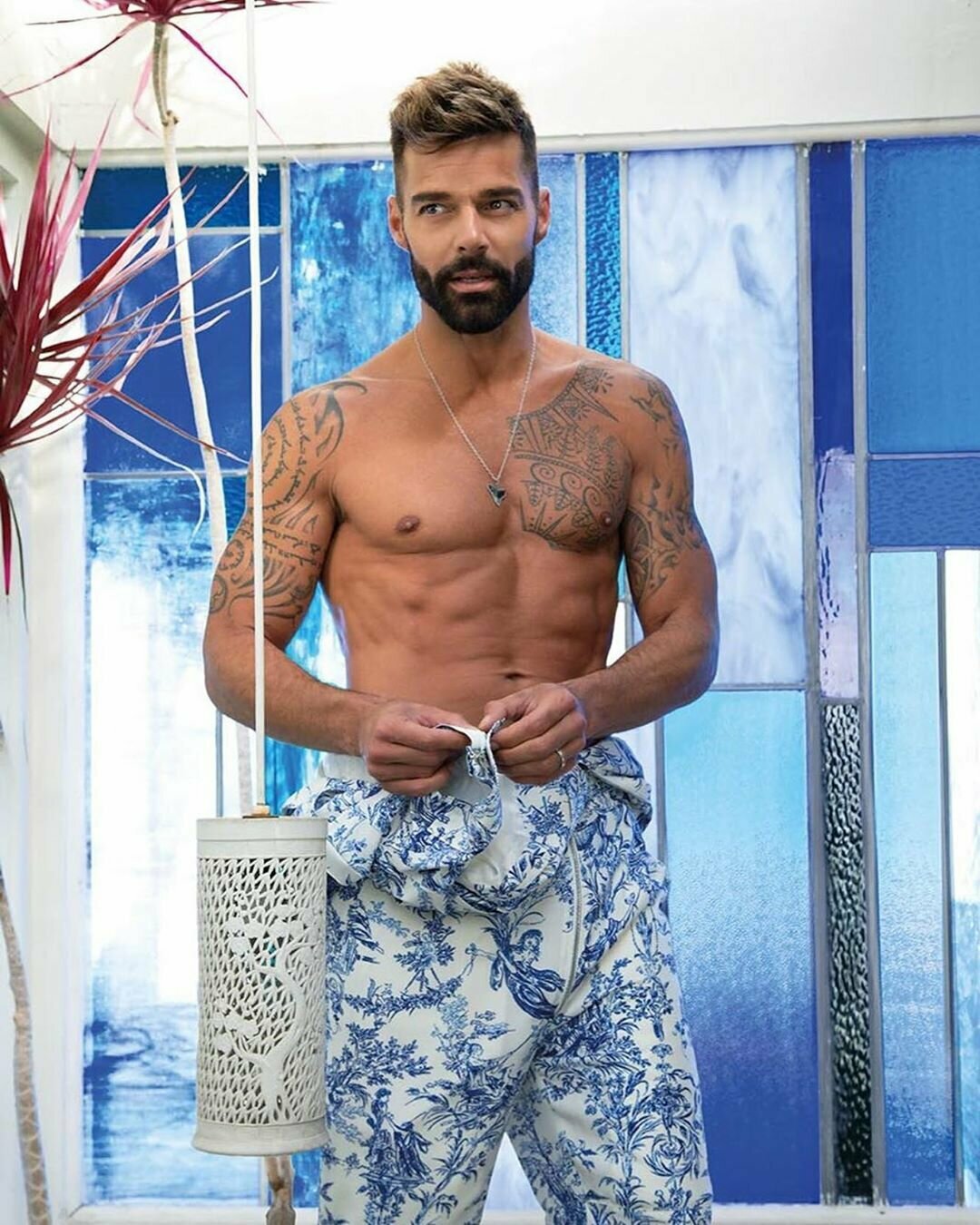 Ricky Martin shirtless showing arm tattoos