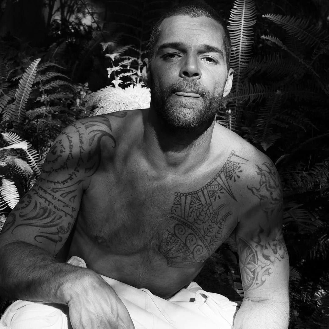 Ricky Martin showing lotus and arm tattoo details