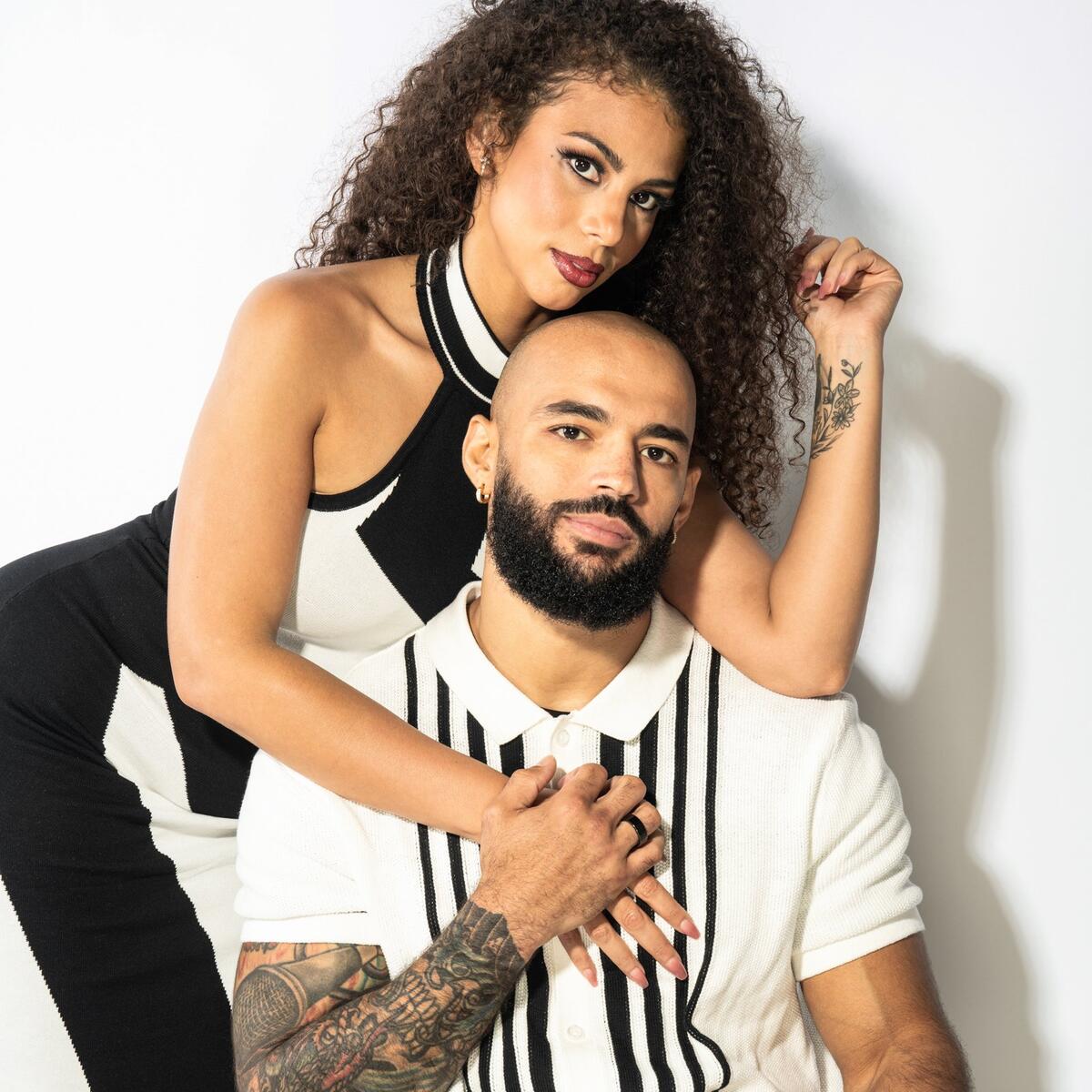 Ricochet tattoos: Chest script lettering and nearby forearm ink