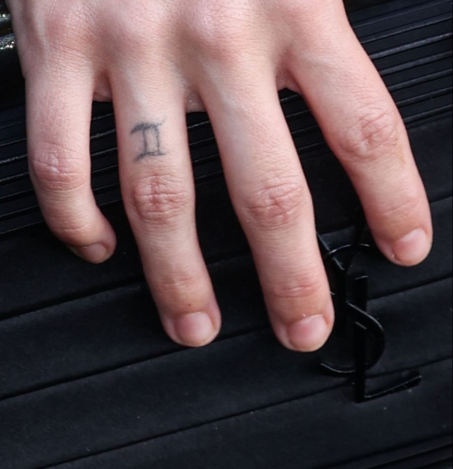 The Gemini symbol tattoo on her ring finger Riley Keough tattoos: inline
