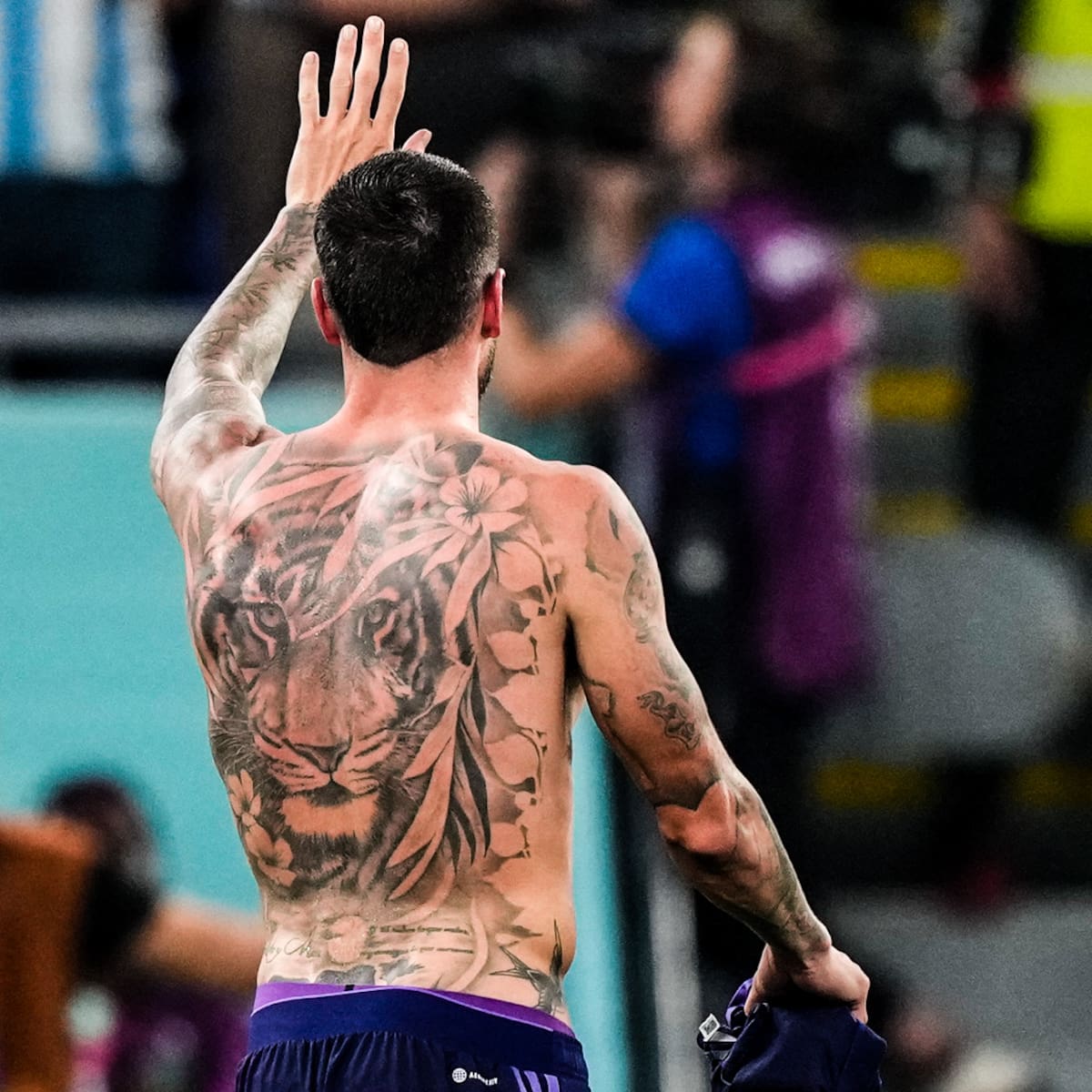 Rodrigo De Paul tattoos: clean rear-view photograph showing the large tiger and flower back tattoo across the shoulders and full back